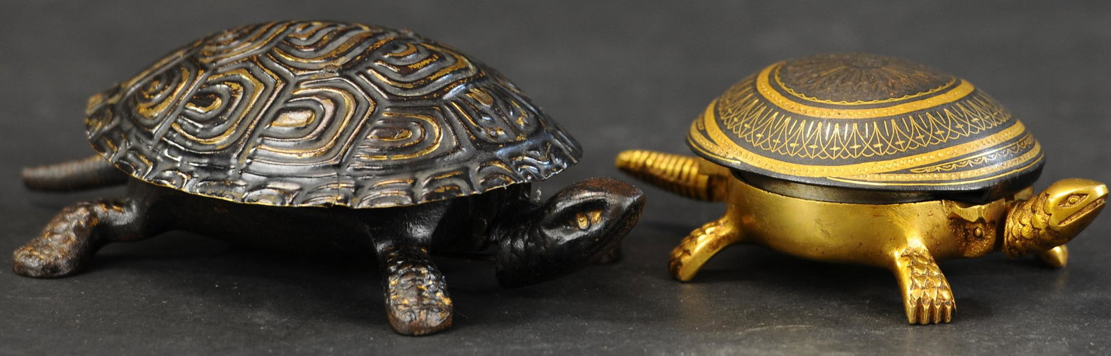 TWO DECORATIVE DESKTOP TURTLES: 325. TWO DECORATIVE DESKTOP TURTLES | Decorative brass turtle, pressing head activates the bell, and a German cast iron heater, press head to open shell, revealing the inside compartment. 5.5" - 6.5" 