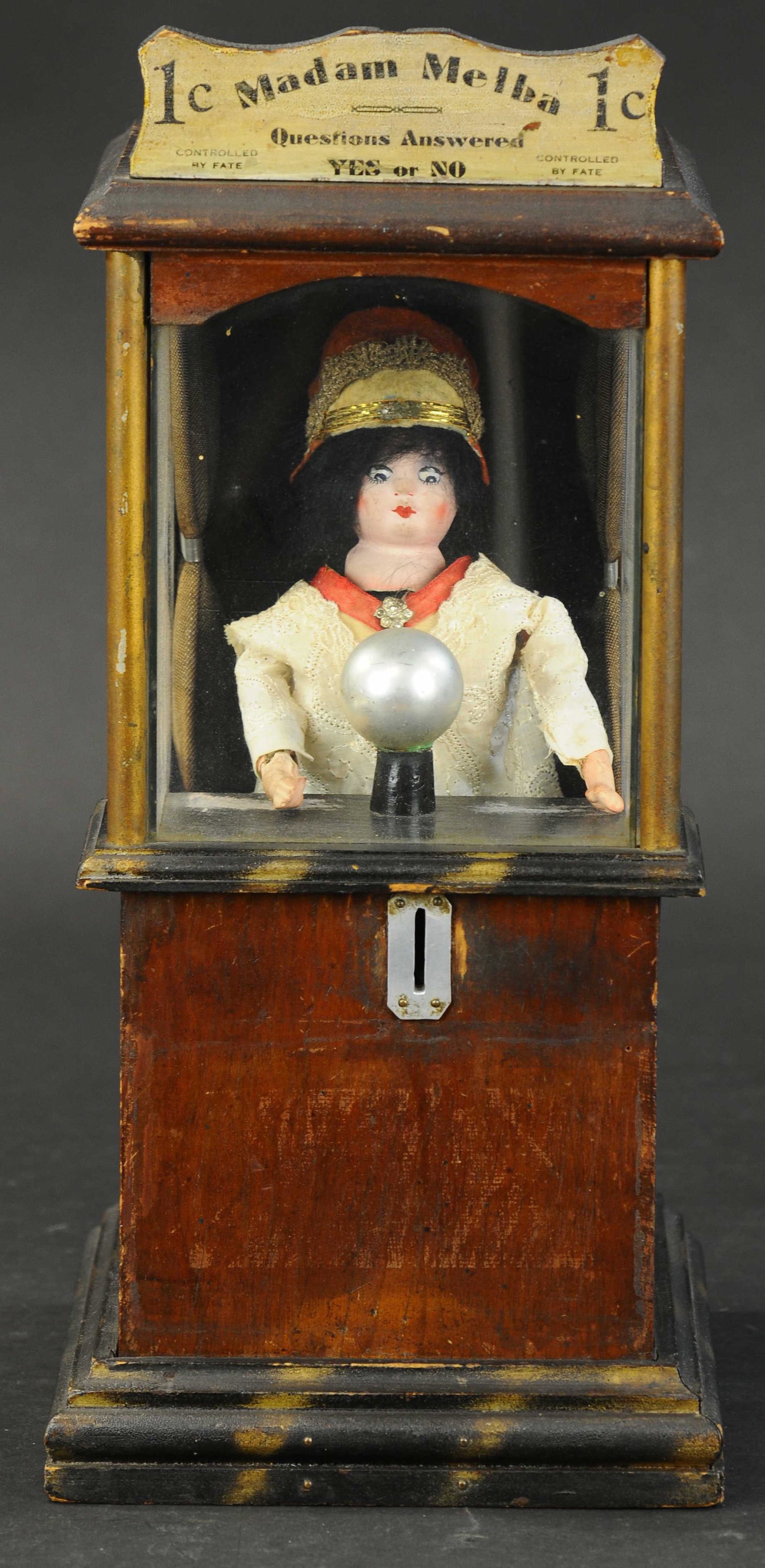 MADAM MELBA COUNTERTOP FORTUNE TELLER MACHINE: 455. MADAM MELBA COUNTERTOP FORTUNE TELLER MACHINE | Countertop amusement machine, "Yes or No," a fine looking wood cabinet with fortune teller figure with crystal ball, she is designed to move her he