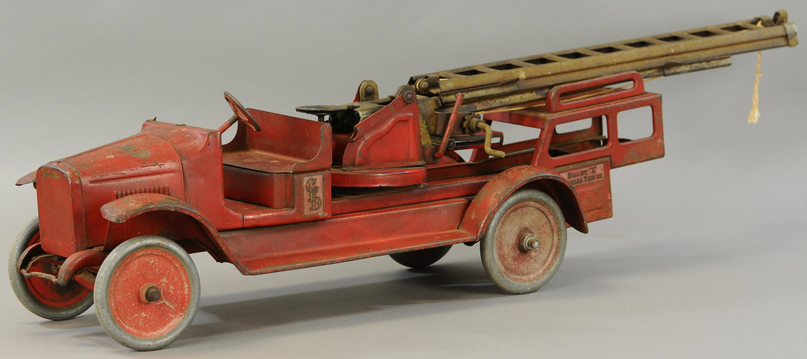 BUDDY L AERIAL LADDER TRUCK: 27. BUDDY L AERIAL LADDER TRUCK | 38" l. | Missing bell and bracket at windshield, otherwise paint in All Original Condition. | $250 - $500