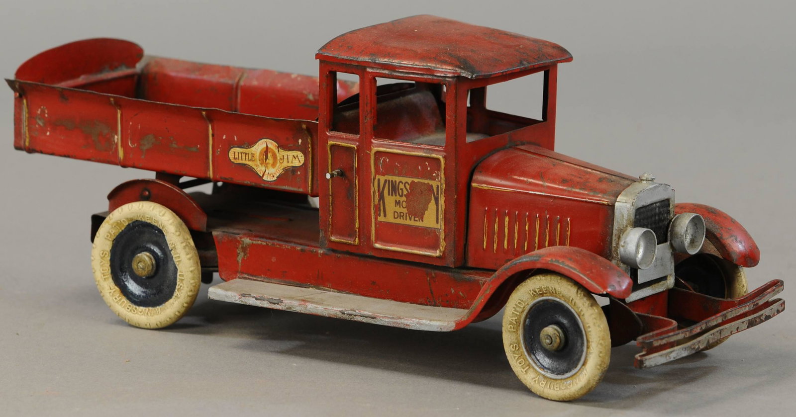 KINGSBURY RED LITTLE JIM DUMP TRUCK: 106. KINGSBURY RED LITTLE JIM DUMP TRUCK | 14" l. | Decals are added, tailgate and one fender are replaced, otherwise paint in All Original Condition. | $300 - $600