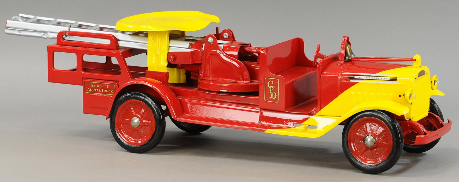 BUDDY L RIDE ON 1934 AERIAL LADDER TRUCK: 131. BUDDY L RIDE ON 1934 AERIAL LADDER TRUCK | 34" l. | Original truck is repainted throughout with steering wheel and seat replaced. | $400 - $800