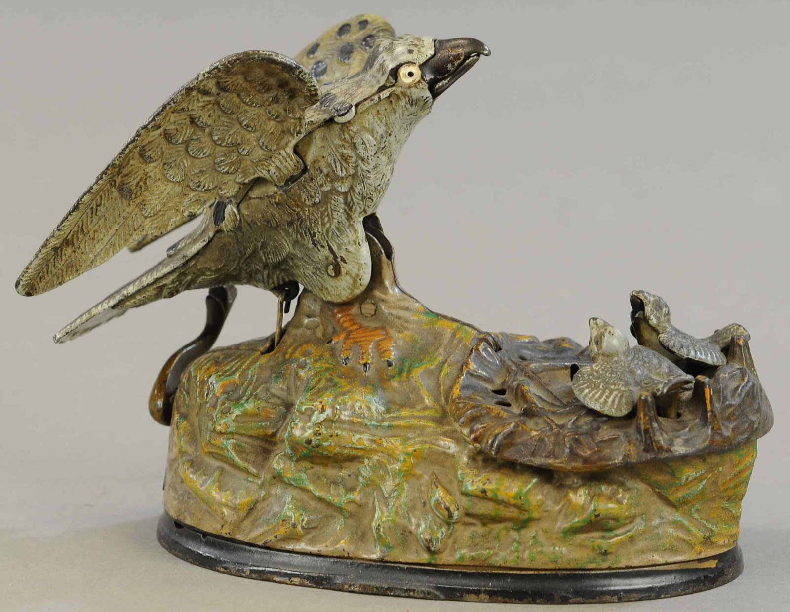 EAGLE AND EAGLETS MECHANICAL BANK: 198. EAGLE AND EAGLETS MECHANICAL BANK | Bellows is working, one wing replaced, otherwise paint in All Original Condition. | $250 - $500