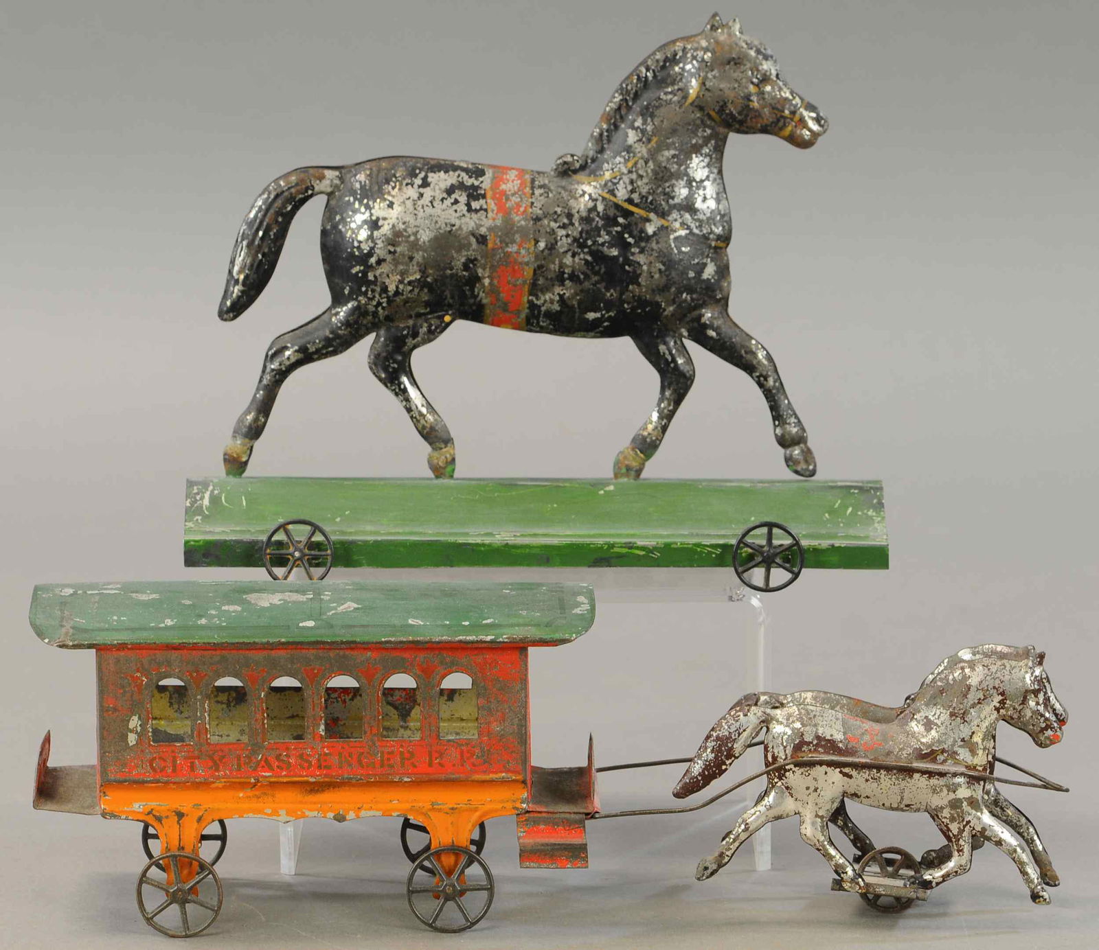 TWO EARLY AMERICAN TIN TOYS: 233. TWO EARLY AMERICAN TIN TOYS | 10.5" - 15" l. | Platform on horse toy is repainted, otherwise both in All Original Condition. | $300 - $600