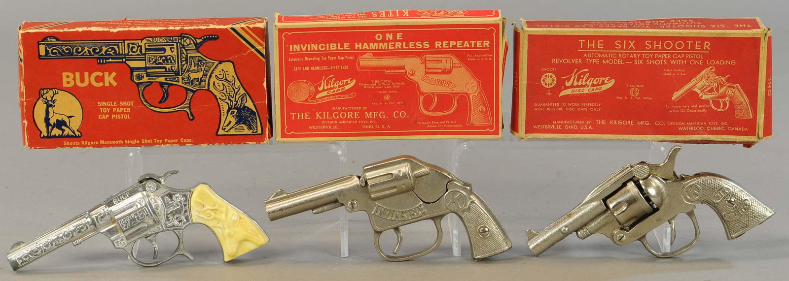 THREE BOXED KILGORE CAP GUNS: 244. THREE BOXED KILGORE CAP GUNS | 7" l. | Boxes have areas of distress, Buck trigger inoperative, otherwise All Original Condition. | $125 - $250