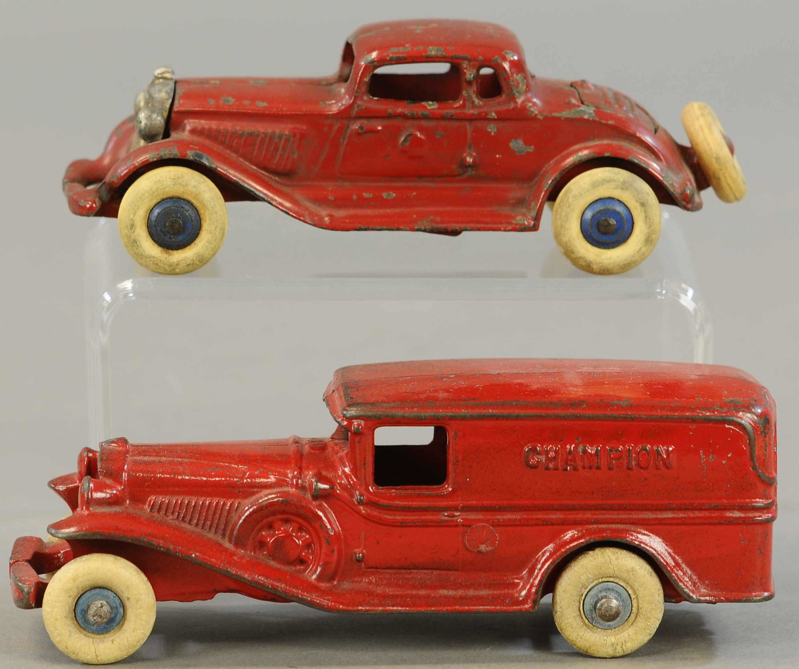 TWO CHAMPION AUTOMOTIVE TOYS: 288. TWO CHAMPION AUTOMOTIVE TOYS | 7" - 8" l. | Coupe paint is restored, van has one wheel with epoxy reinforcement. | $300 - $600