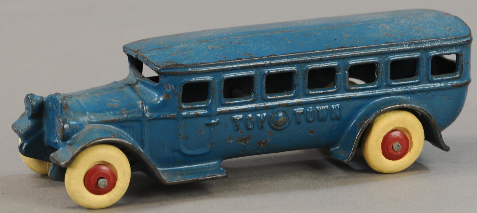 KILGORE TOY TOWN BUS: 299. KILGORE TOY TOWN BUS | 8" l. | Wheels vintage, but not correct for toy, small factory crack at window on right side, reflects OK under UV blacklight, though appears to be overpainted. | $100 - $2