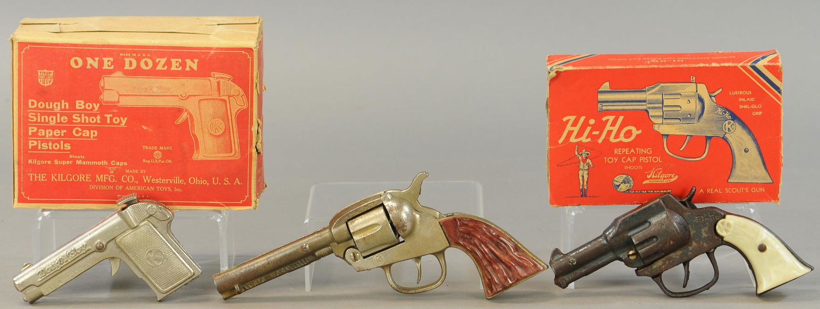 THREE KILGORE CAP PISTOLS: 302. THREE KILGORE CAP PISTOLS | Lot includes: Dough Boy, HiHo, & Big Horn examples. | 5" - 9" l. | Boxes are distressed, side flaps missing on HiHo box, guns are in All Original Condition. | $100 - $