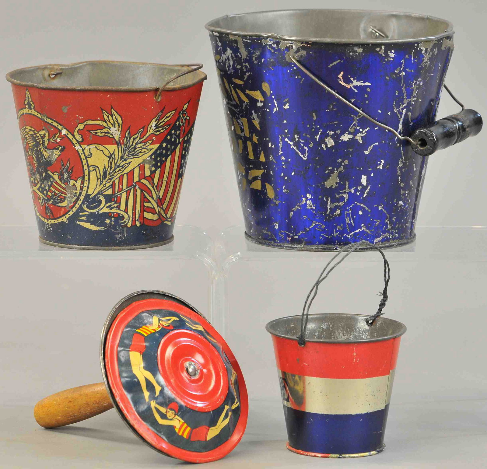 THREE SAND PAILS AND NOISEMAKER: 362. THREE SAND PAILS AND NOISEMAKER | Three bail handle pails and patriotic noisemaker. | 3" - 5.5" h. | Some overall wear to the pails, otherwise (Fair-Good Cond.) | $100 - $200