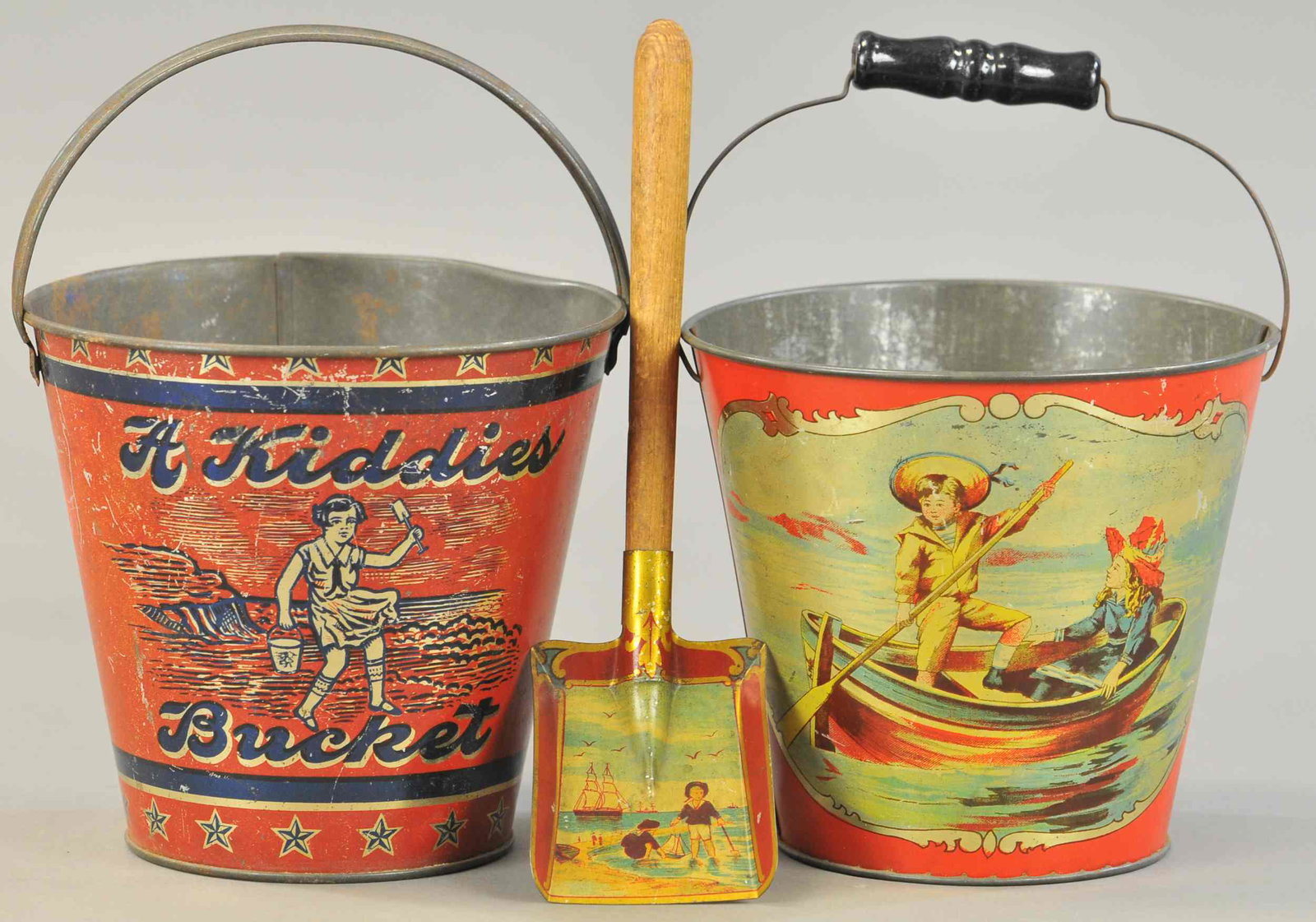 TWO EARLY TIN LITHO SAND PAILS: 363. TWO EARLY TIN LITHO SAND PAILS | Bail handle with sea-side scenes and kiddies bucket. | Each 6" h. | (VG-Exc. Cond.) | $250 - $500