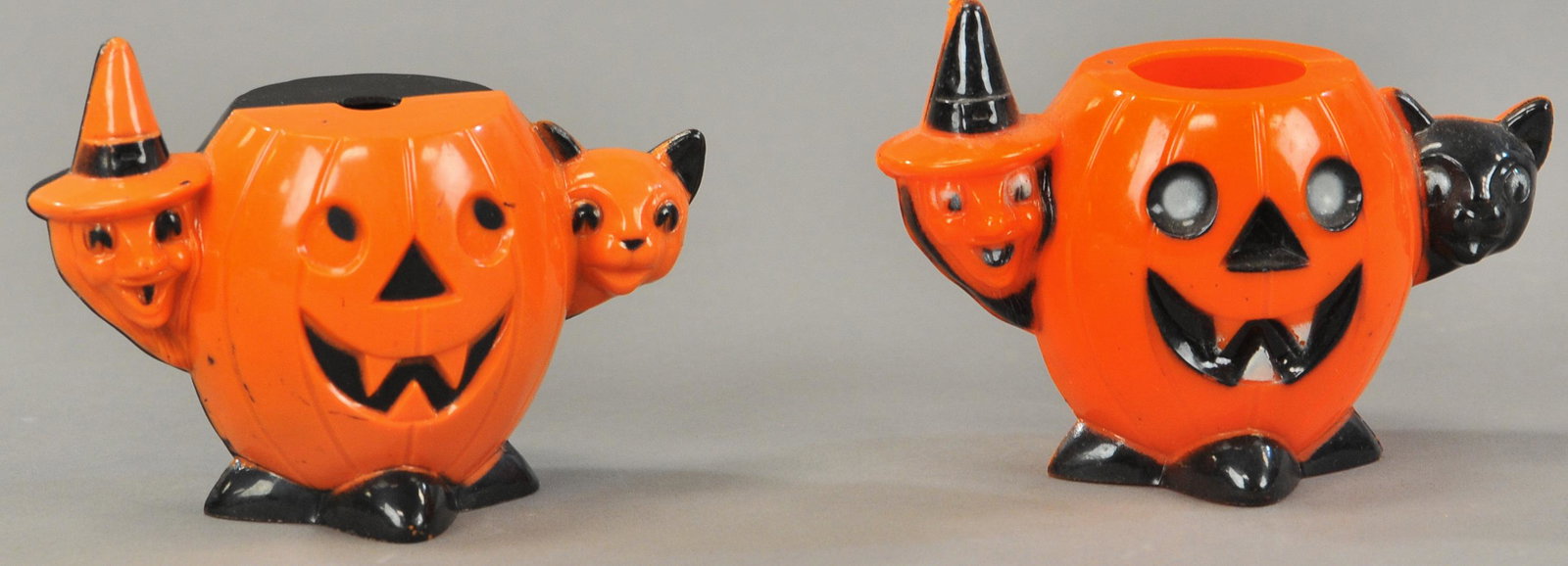 TWO HARD PLASTIC JACK-O-LANTERNS WITH WITCH & CAT: 373. TWO HARD PLASTIC JACK-O-LANTERNS WITH WITCH & CAT | 4" h. each. | (Exc. Cond.) | $50 - $100