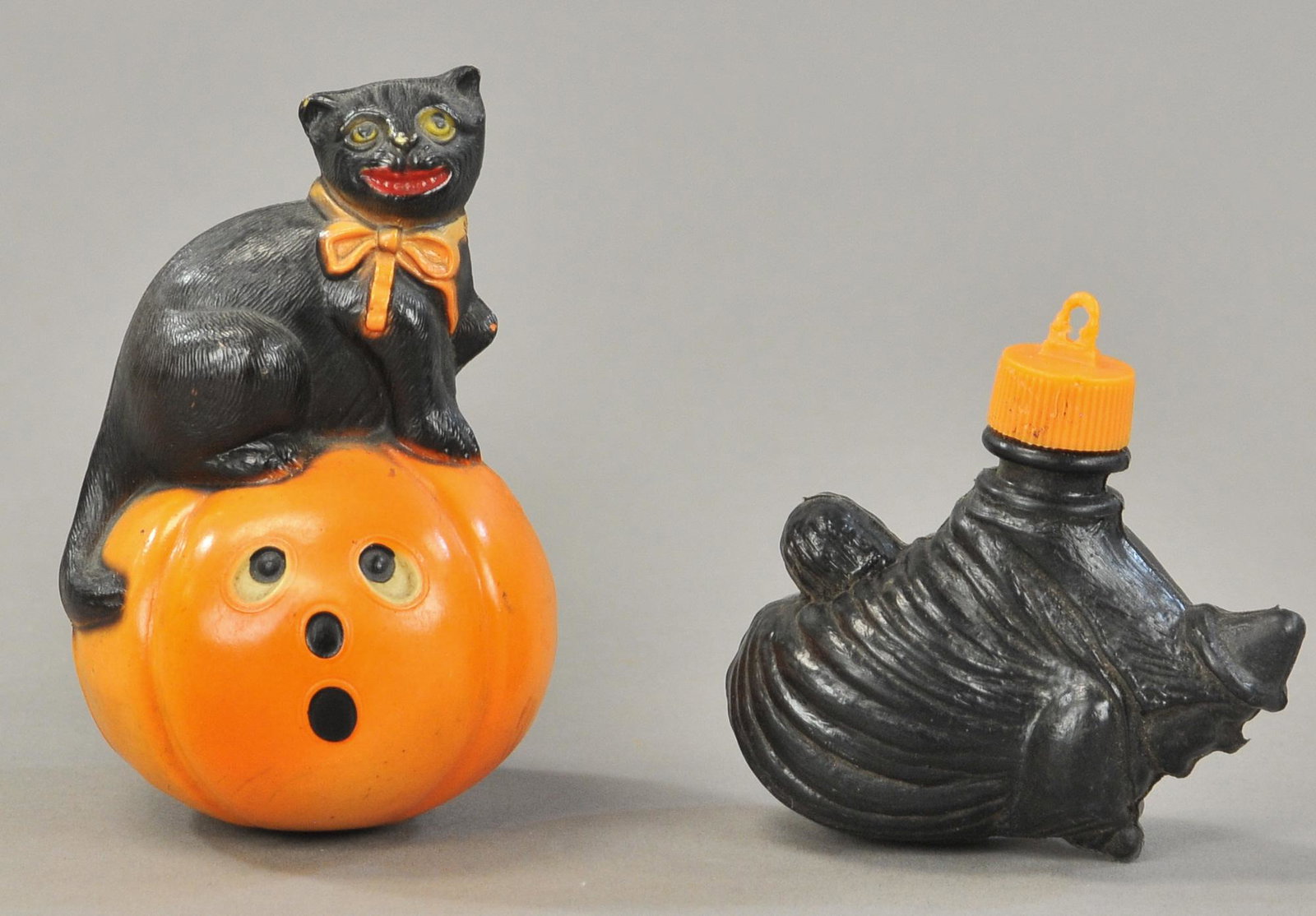 CELLULOID BLACK CAT & WITCH CANDY CONTAINERS: 376. CELLULOID BLACK CAT & WITCH CANDY CONTAINERS | One plastic and one celluloid Halloween figures. | 3" each. | (VG Cond.) | $200 - $400