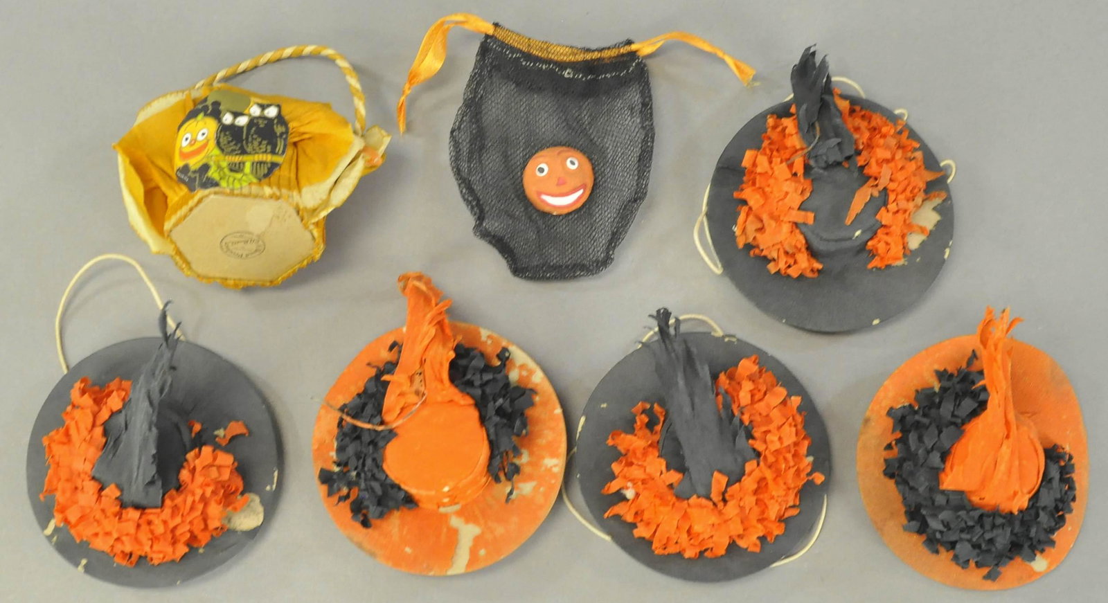 GROUPING OF HALLOWEEN PARTY NOVELTIES: 383. GROUPING OF HALLOWEEN PARTY NOVELTIES | Five hats with chin straps and two candy baskets. | 3" - 4" l. | (VG Cond.) | $50 - $100