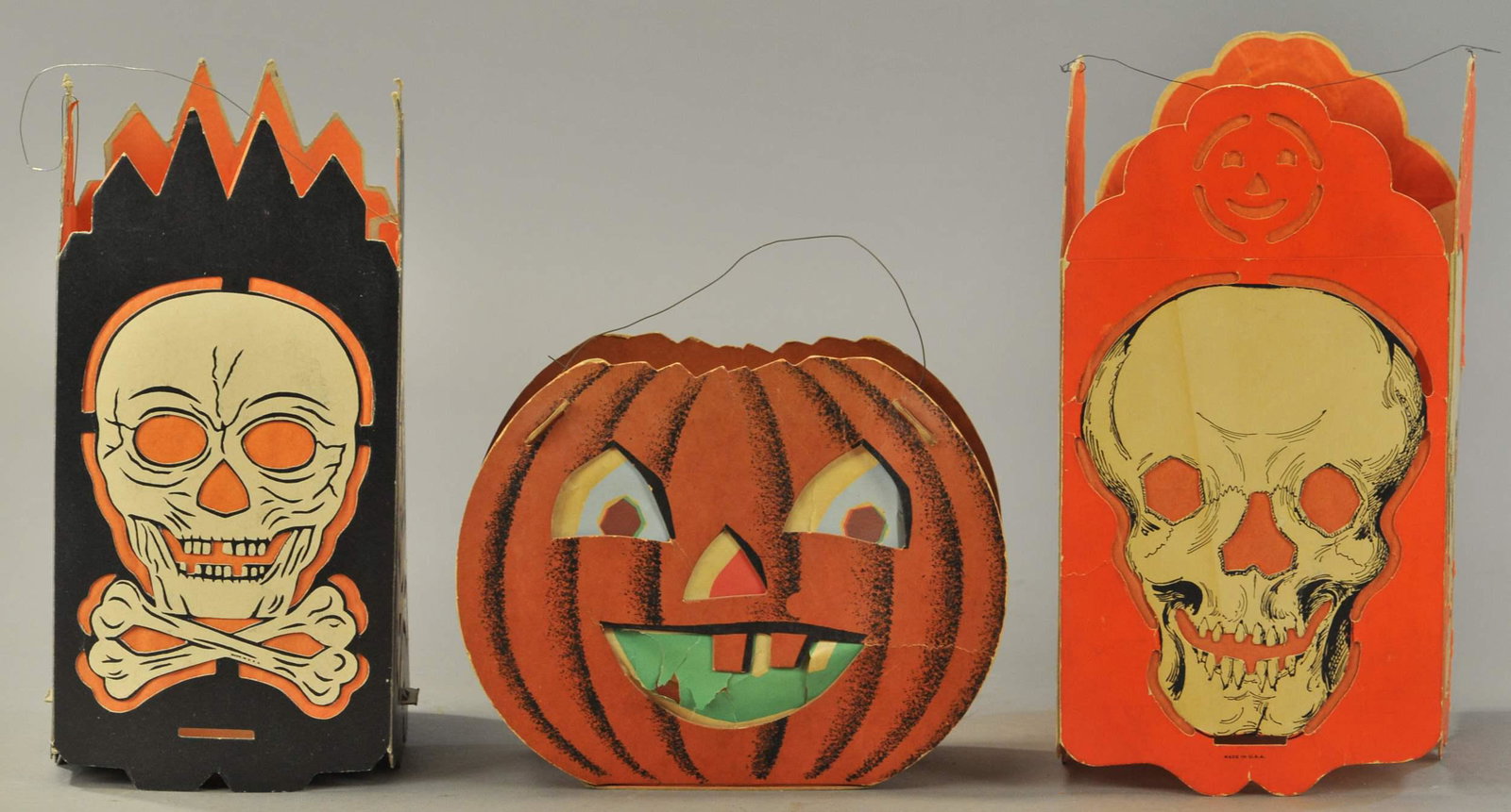 THREE FOLD-OUT HALLOWEENLANTERNS: 437. THREE FOLD-OUT HALLOWEENLANTERNS | Lanterns printed on heavy cardboard with tab & slot construction, dual-sided JOL has a different expression on each side, scull & crossbones and skull are four-