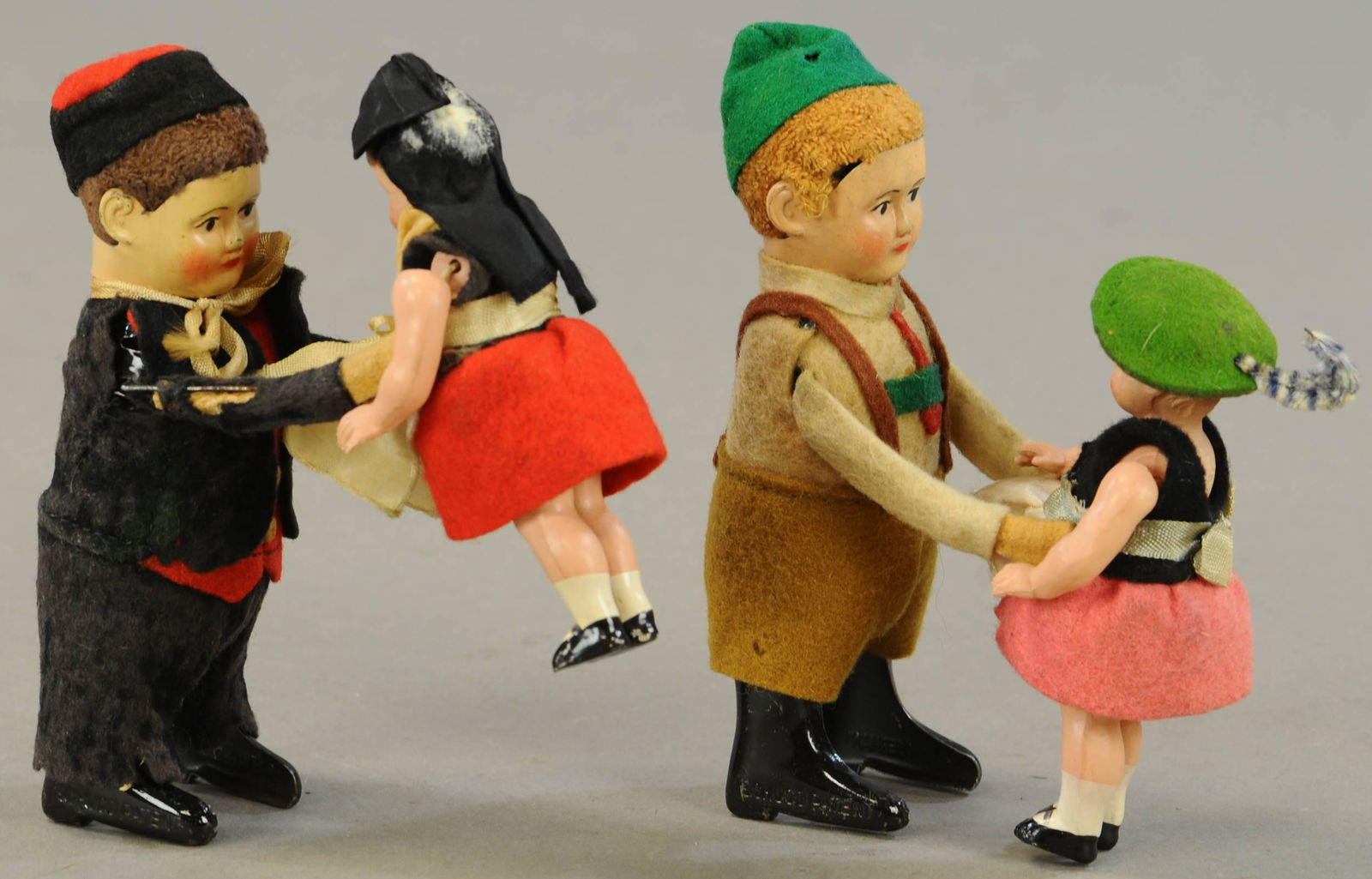 TWO SCHUCO FIGURES LIFTING CHILD (1 of 3)