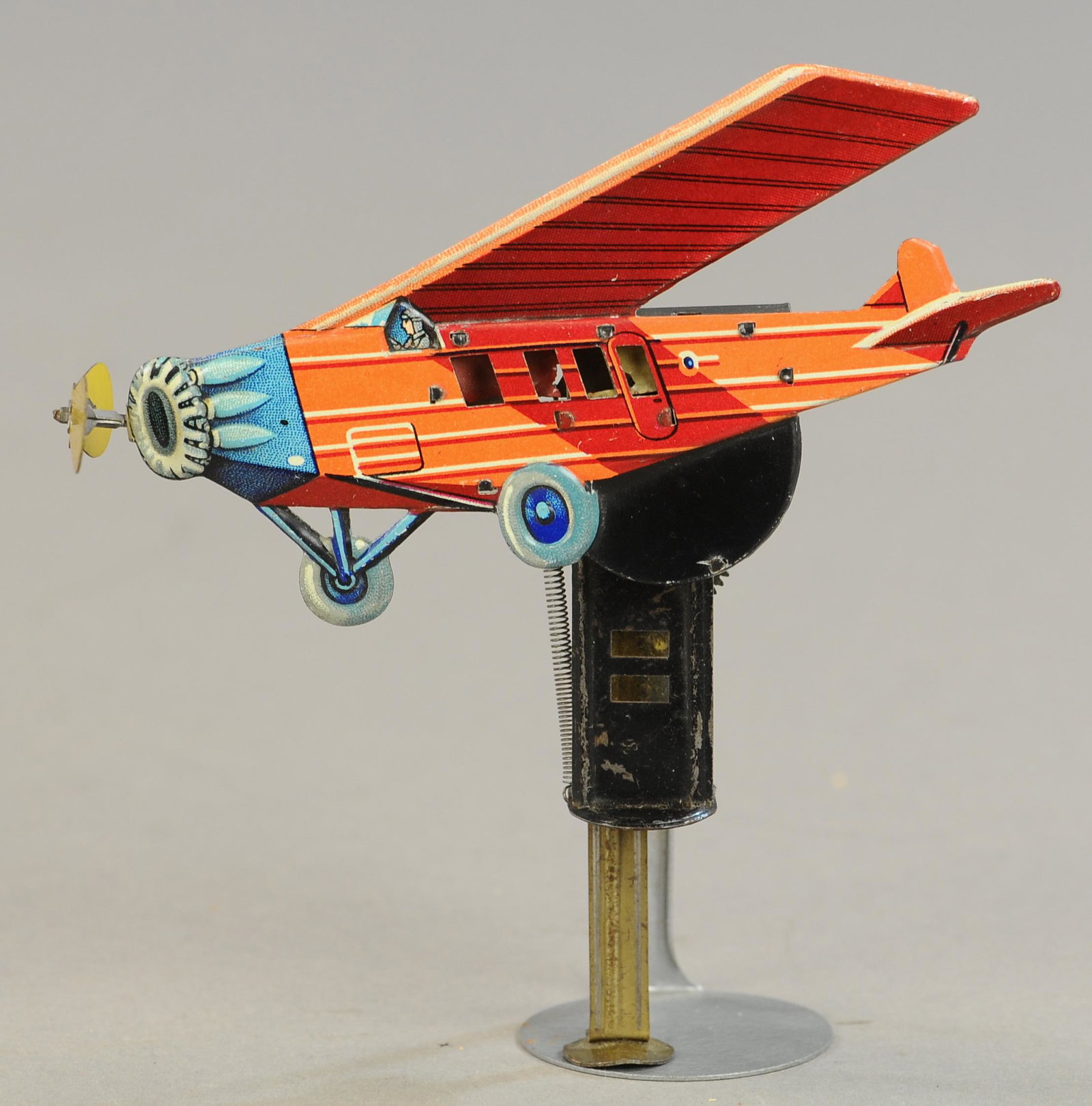 AIRPLANE HAND-SQUEEZE SPARKLER: 203. AIRPLANE HAND-SQUEEZE SPARKLER | 5.5" l. | Flint is sparking nicely, however propeller spins freely, tin in All Original Condition. | $200 - $400