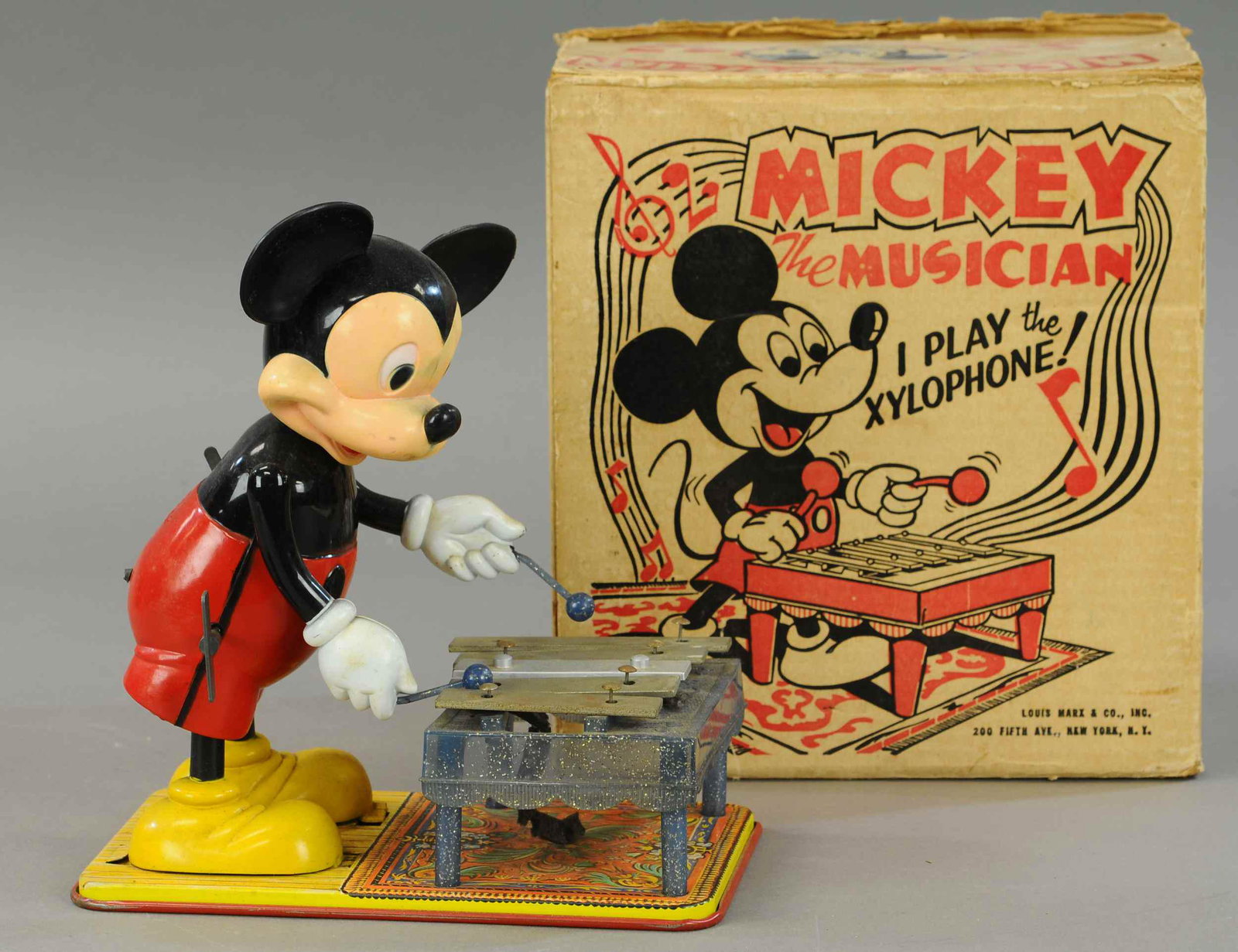 BOXED MICKEY THE MUSICIAN: 428. BOXED MICKEY THE MUSICIAN | 11" h. | Right arm is attached and working, though needs adjustment to swing sticks well, tin in All Original Condition. | $200 - $400