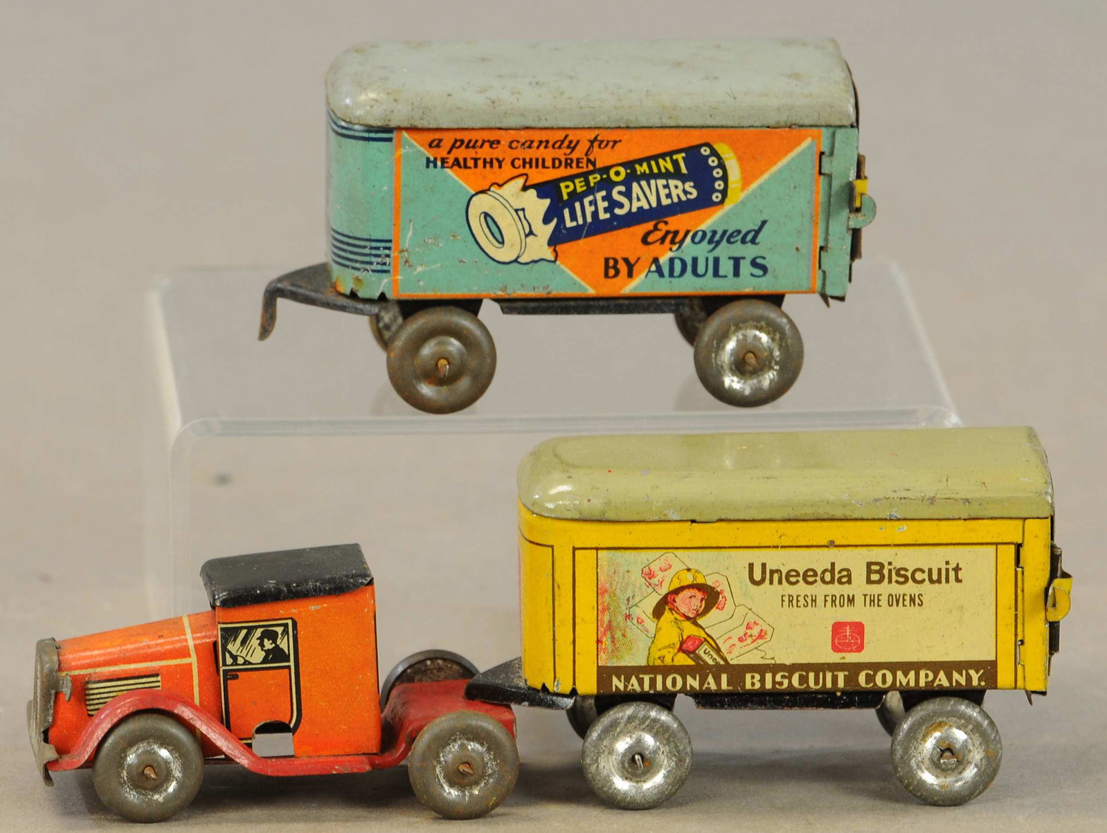 LINDSTROM TRACTOR TRAILER - LIFESAVER & UNEEDA: 11. LINDSTROM TRACTOR TRAILER - LIFESAVER & UNEEDA | BISCUIT | 6" l. | Tractor portion without mechanism, doesn't appear to have ever had one on this example, All Original Condition. | $150 - $300