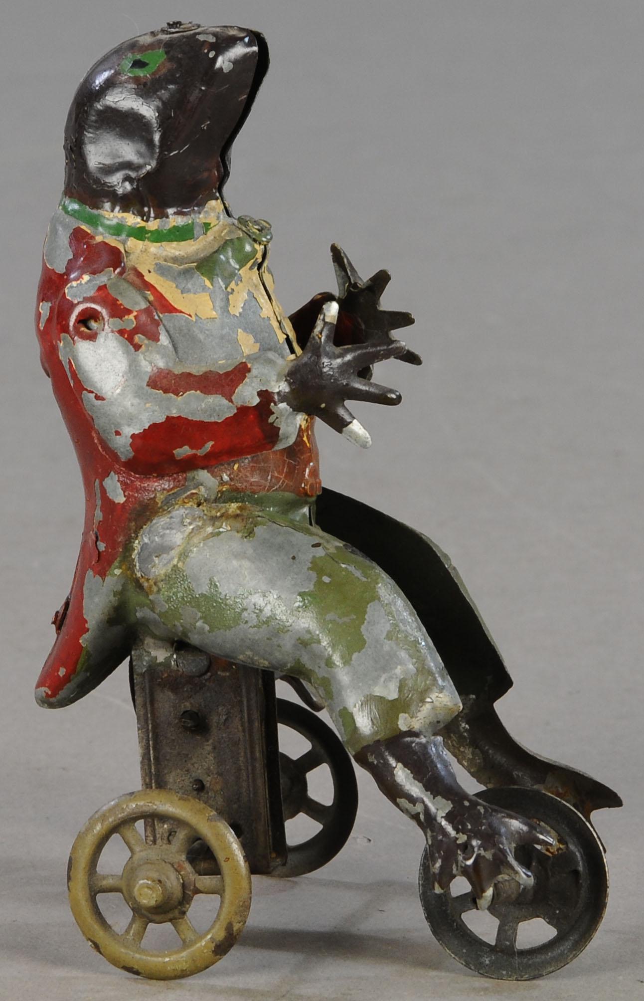 GERMAN TIN FROG WIND-UP TOY: 45. GERMAN TIN FROG WIND-UP TOY | 6.5" h. | Toy appears to be original paint, though clear coat sprayed to preserve it from flaking. | $200 - $400