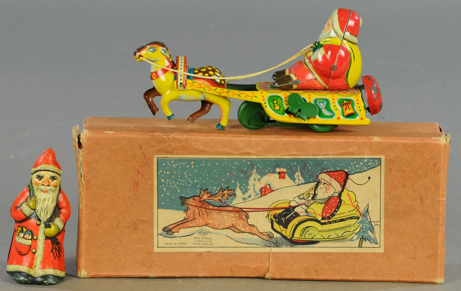 BOXED SANTA SLEIGH W/ ARNOLD WIND-UP: 82. BOXED SANTA SLEIGH W/ ARNOLD WIND-UP | 4" - 7" l. | Bell on rear of Santa sleigh is replaced, All Original Condition. | $200 - $400