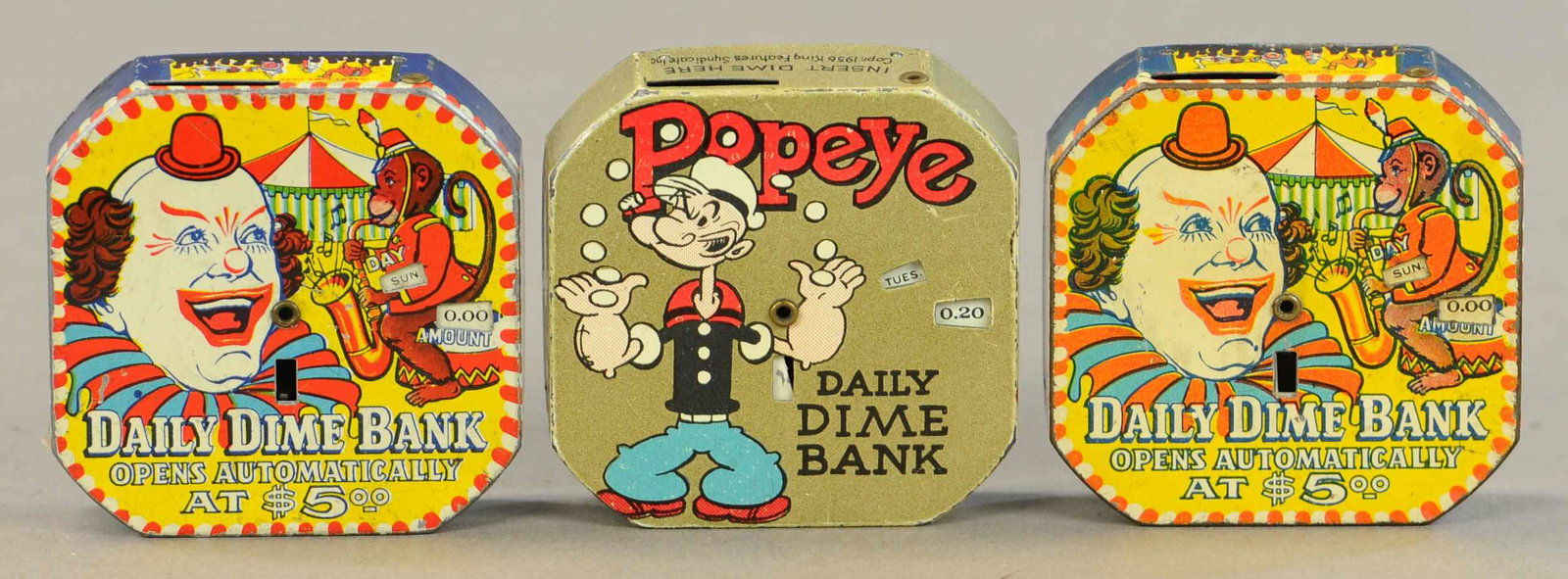 THREE TIN DIME SAVINGS BANKS - POPEYE: 95. THREE TIN DIME SAVINGS BANKS - POPEYE | 2.5" l. | All Original Condition. | $100 - $200