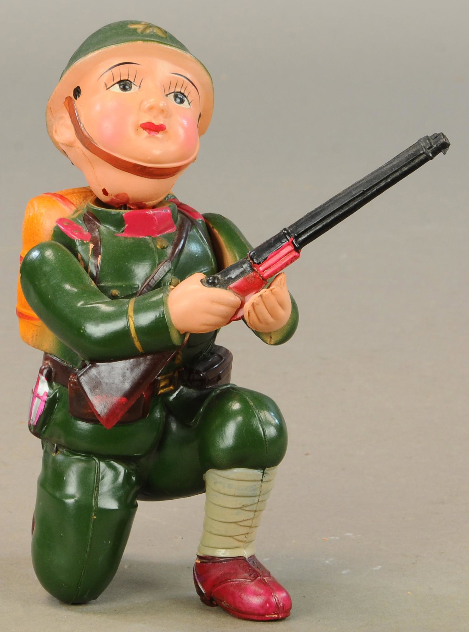 CELLULOID WIND UP SOLDIER BOY: 105. CELLULOID WIND UP SOLDIER BOY | 9" h. | Head is disconnected, crack repair along waistline, working condition. | $100 - $200