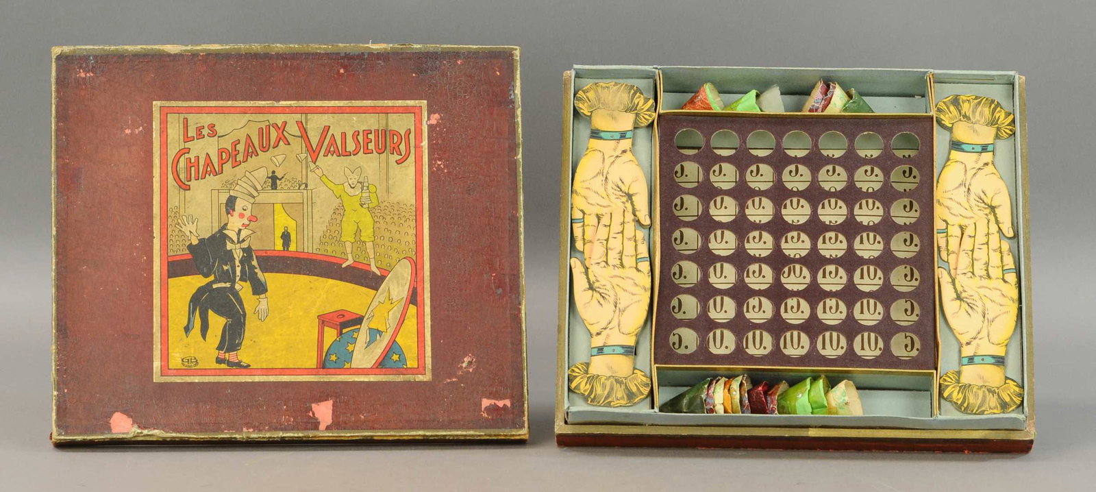 FRENCH CLOWN HAND TOSS GAME: 161. FRENCH CLOWN HAND TOSS GAME | 13" l. | Age appropriate wear to box lid, otherwise in All Original Condition. | $75 - $150