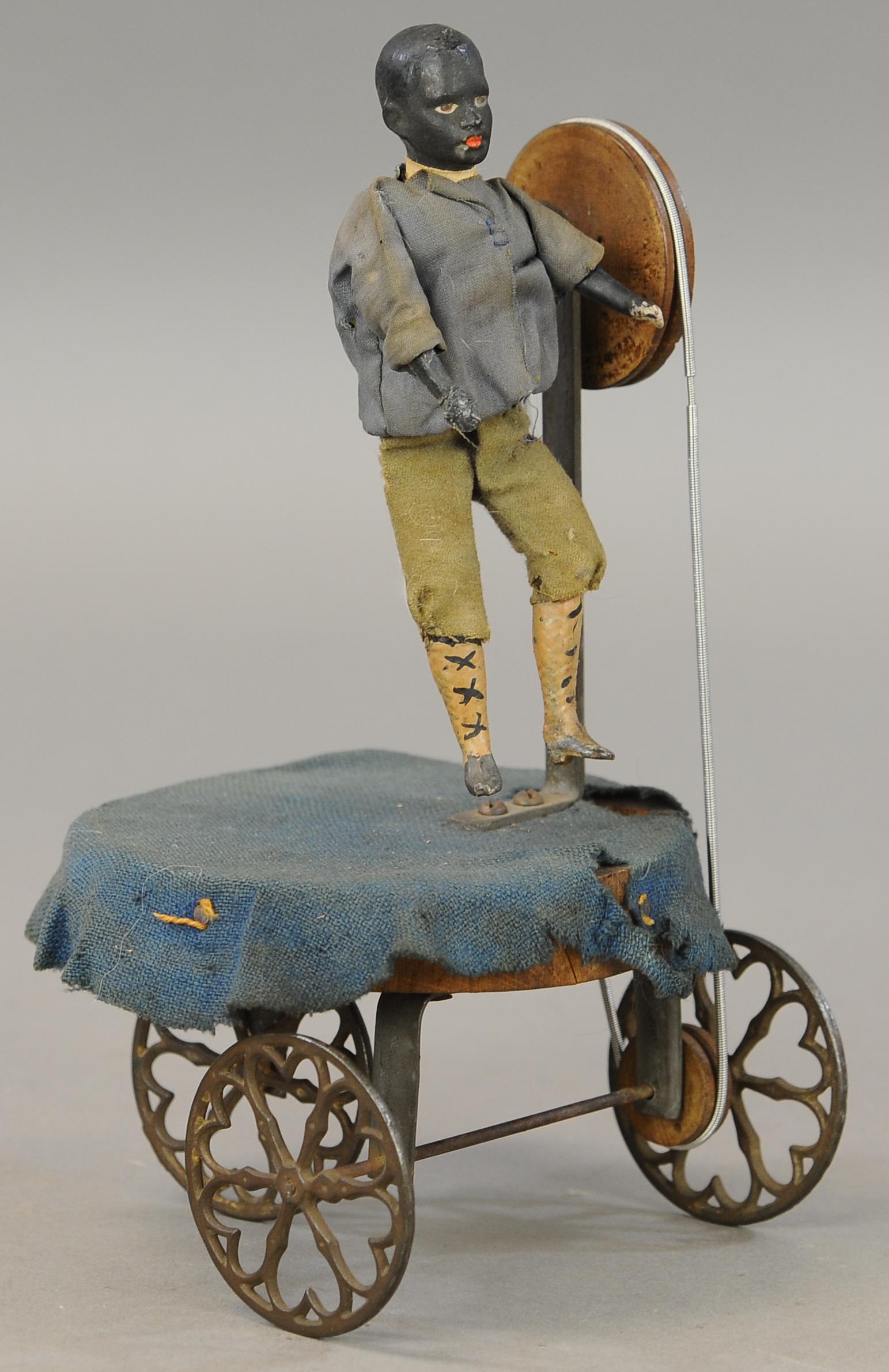 ANIMATED BLACK AMERICANA ACROBAT PULL TOY: 189. ANIMATED BLACK AMERICANA ACROBAT PULL TOY | 9" h. | Some minor touch up to figure, clothing distress, otherwise in All Original Condition. | $300 - $600