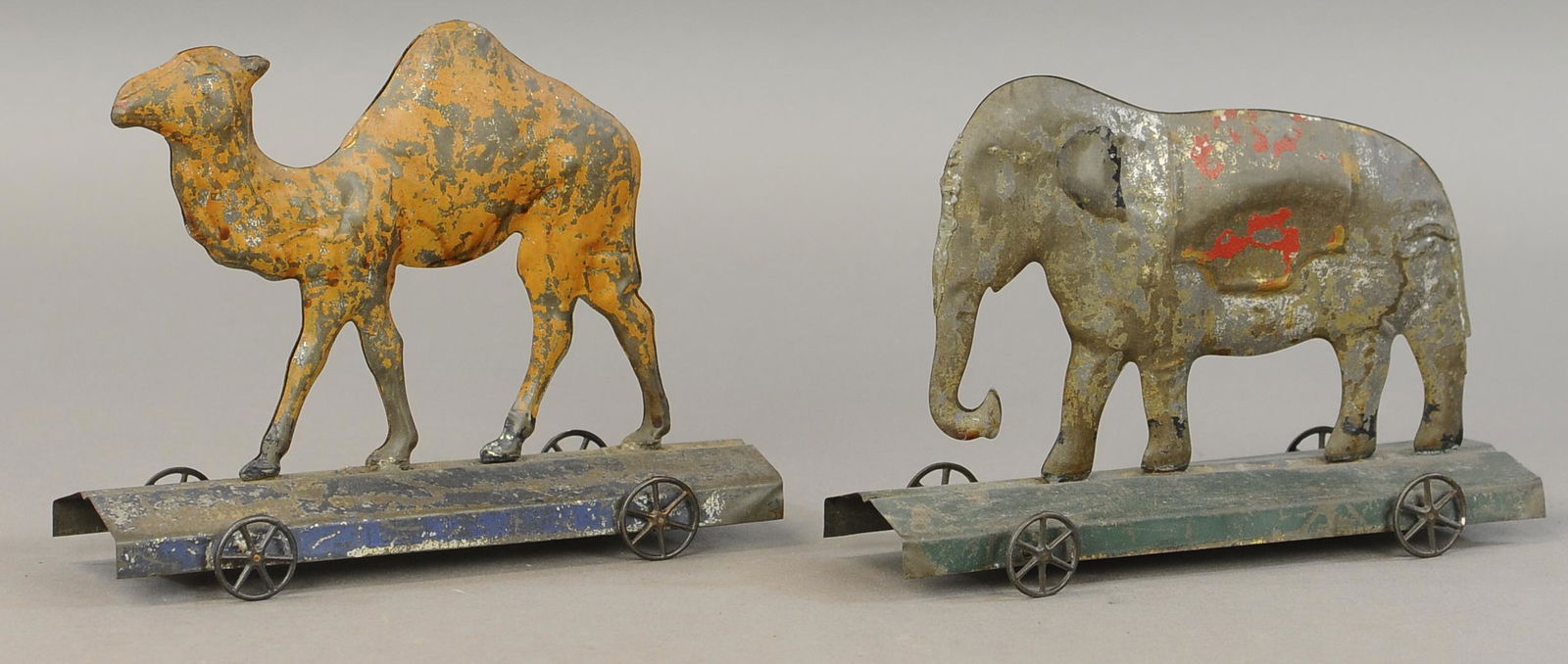 TWO LARGE AMERICAN TIN PLATFORM TOYS: 197. TWO LARGE AMERICAN TIN PLATFORM TOYS | 9" l. | Elephant has some denting and old re-solder, camel is All Original Condition. | $200 - $400