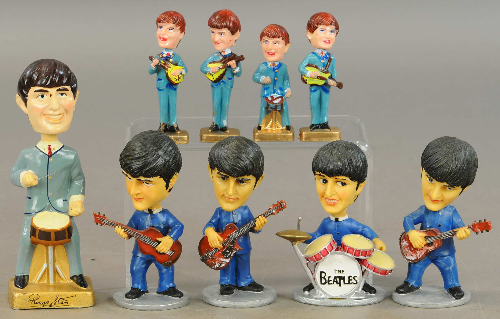 GROUPING OF BEATLE BOBBLEHEADS: 259. GROUPING OF BEATLE BOBBLEHEADS | Set of four small figurines, Ringo w/signature and cake toppers. | 4" - 7.5" h. | (Exc.-Near Mint Cond.) | $150 - $300