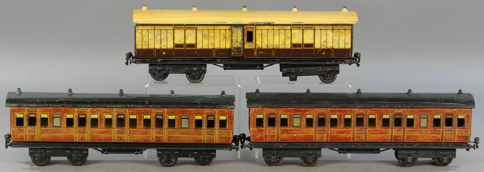 THREE MARKLIN ENGLISH MARKET COACHES: 291. THREE MARKLIN ENGLISH MARKET COACHES | Gauge 1, litho. | Each 16" l. | Baggage car missing one pair of wheels, white roof repainted, one coach has solder marks at ends, otherwise in All Original