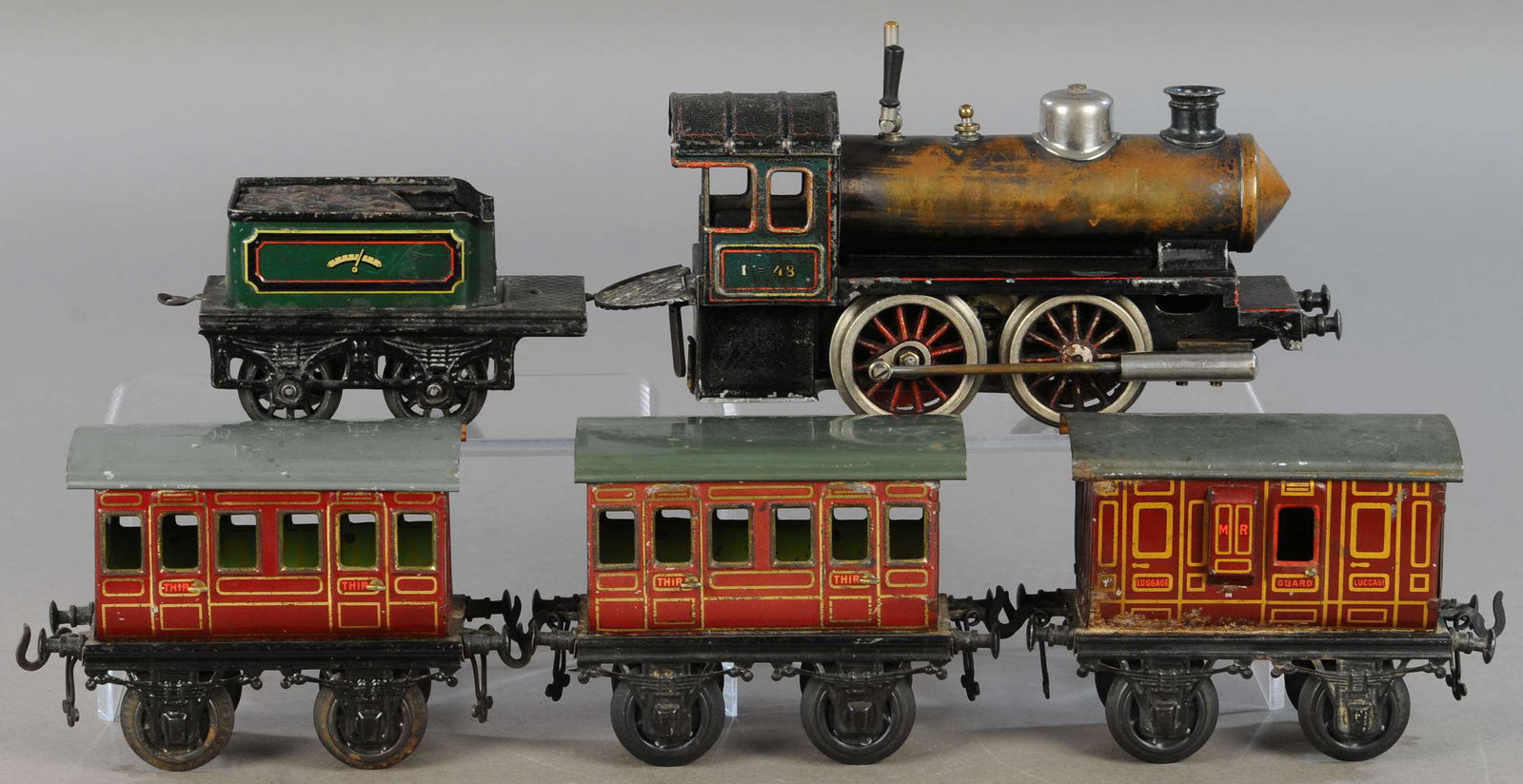 BING LIVE STEAM LOCOMOTIVE AND CARS: 293. BING LIVE STEAM LOCOMOTIVE AND CARS | Gauge 1, live steam, litho. | Loco & tender 13" l. | Loco has clear coat spray to preserve paint, All Original Condition. | $250 - $500