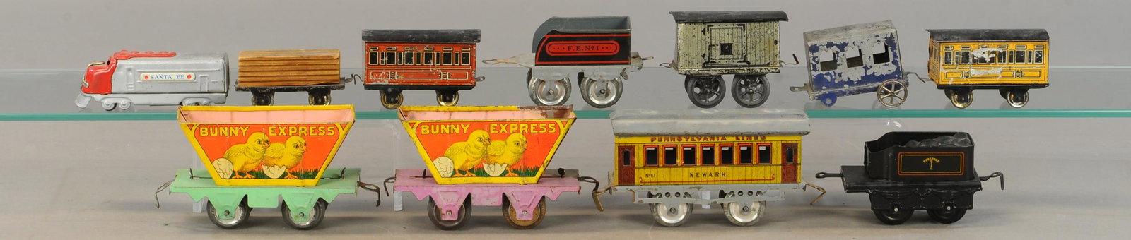 LOT OF IVES, HESS & MARX TRAIN CARS: 320. LOT OF IVES, HESS & MARX TRAIN CARS | Gauge O and smaller floor trains. | 5" l. | Condition wear ranges throughout, appears in All Original Condition. | $300 - $600