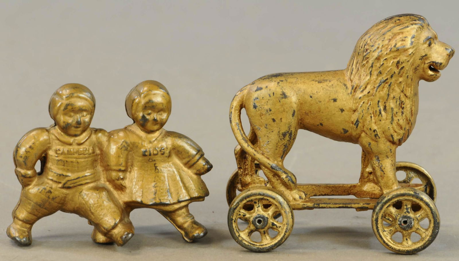 CAMPBELL KIDS & LION ON WHEELS BANKS: 391. CAMPBELL KIDS & LION ON WHEELS BANKS | 4" - 5" l. | Lion is repainted, other in All Original Condition. | $100 - $200