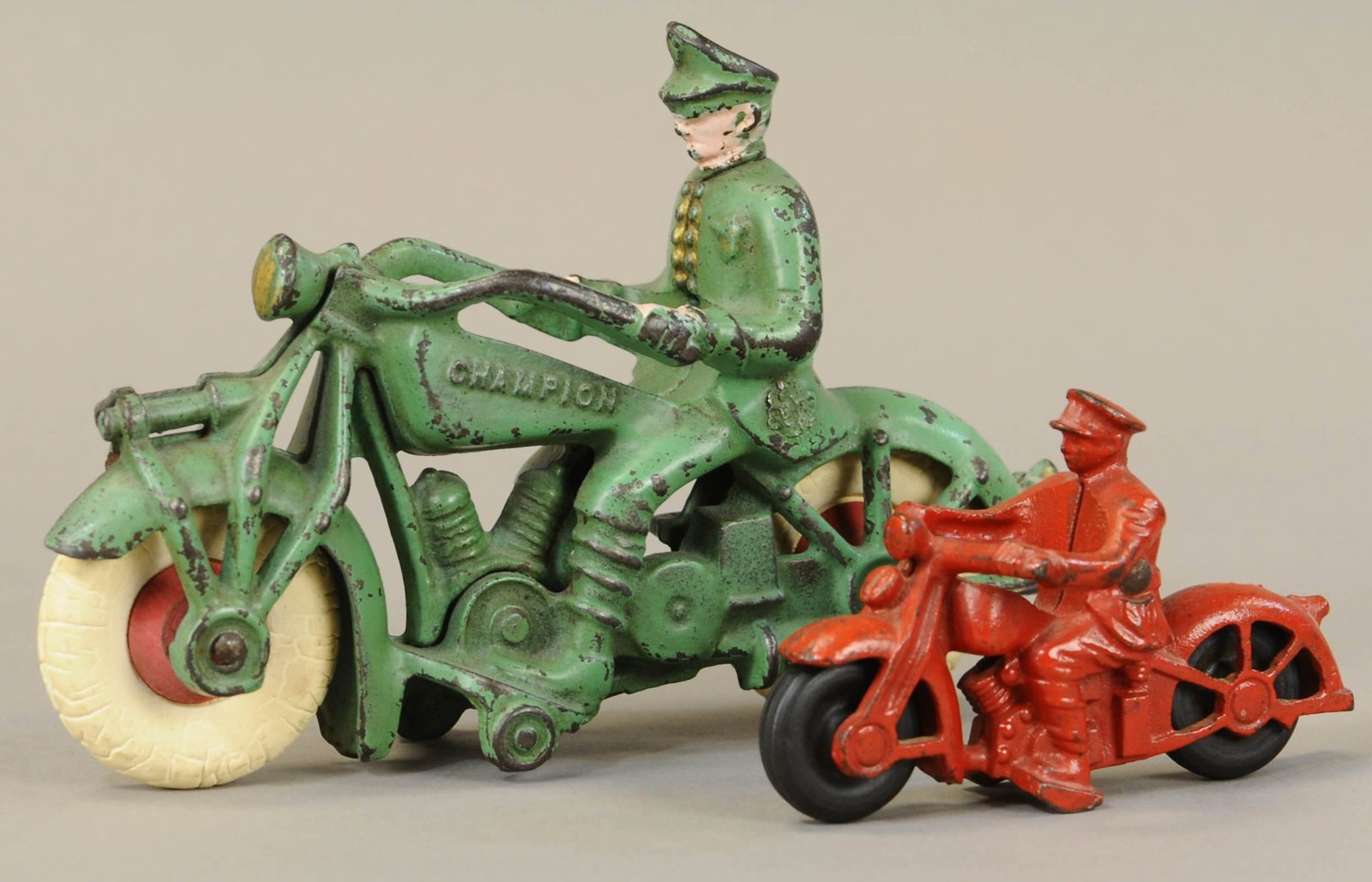 TWO SOLO POLICE MOTORCYCLES: 544. TWO SOLO POLICE MOTORCYCLES | 7.5" l. | Large green has chip to front fender, otherwise in All Original Condition. | $100 - $200