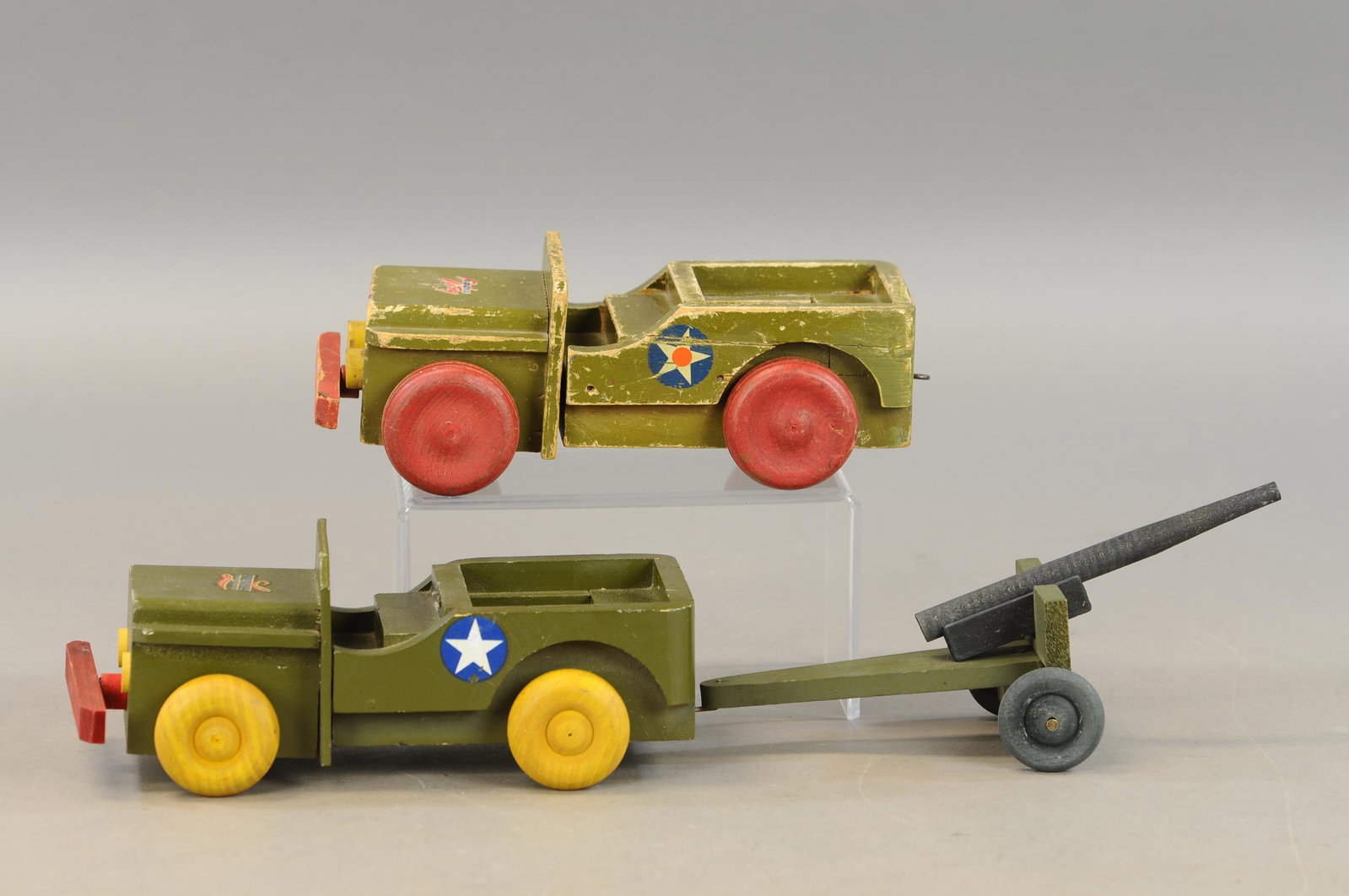 TWO BUDDY L WOOD ARMY TRUCKS: 606. TWO BUDDY L WOOD ARMY TRUCKS | 10" - 19" l. | One replaced wheel and bumper, otherwise in All Original Condition. | $100 - $200