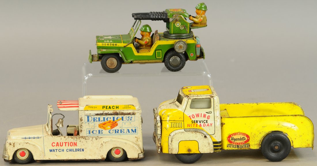 THREE ASSORTED TIN TOY TRUCKS: 86A. THREE ASSORTED TIN TOY TRUCKS | Lot includes: Ice Cream truck, tow truck & Army Air Command Jeep. | All Original Condition. | $150 - $300