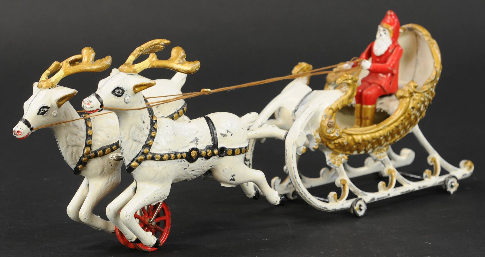 HUBLEY SANTA SLEIGH PULLED BY REINDEER: 95. HUBLEY SANTA SLEIGH PULLED BY REINDEER | A very popular and desirable toy, cross-collectible between Christmas aficionados as well as cast iron collectors. Provenance: The Karyl Newman Christmas C