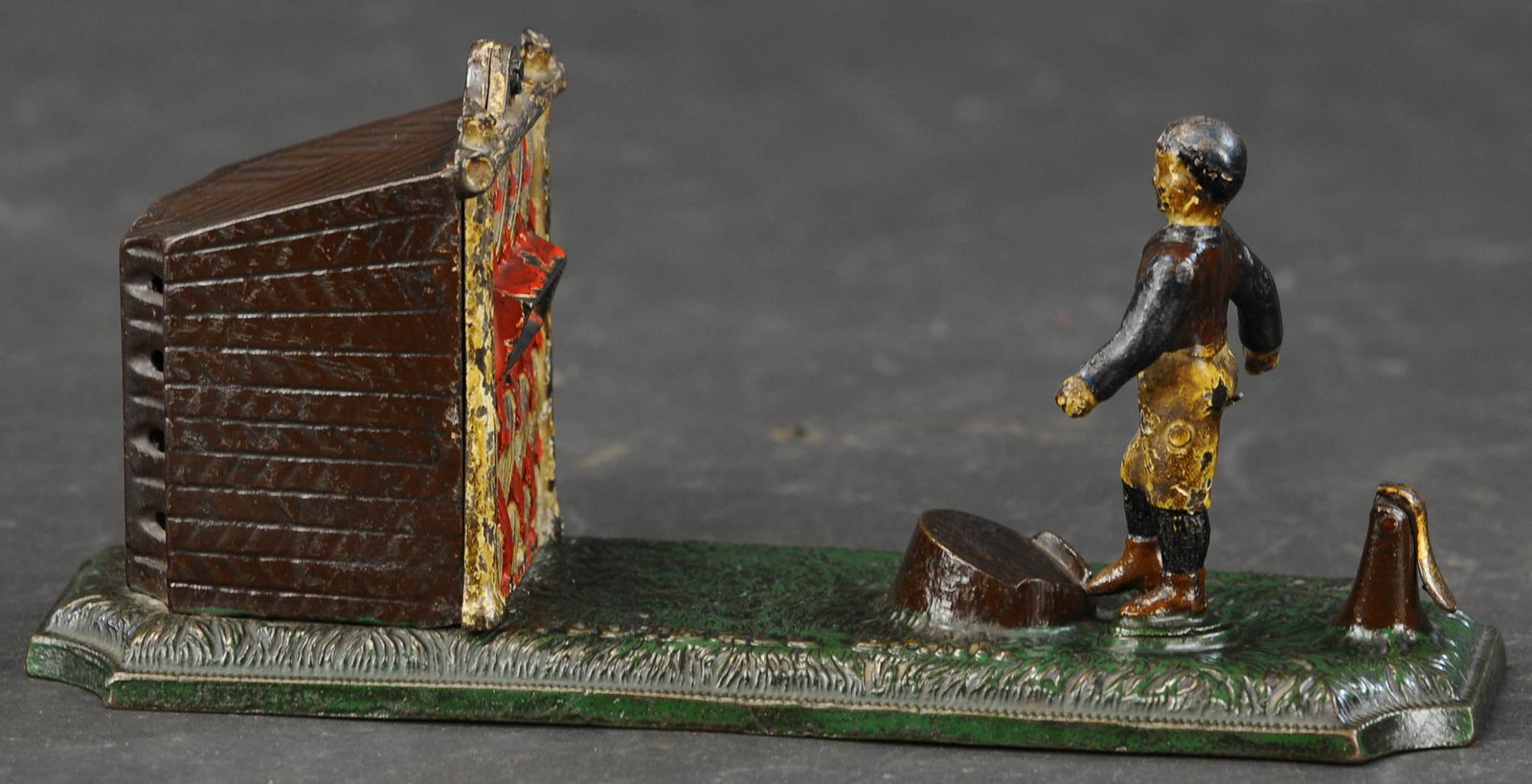 ENGLISH FOOTBALL MECHANICAL BANK: 233. ENGLISH FOOTBALL MECHANICAL BANK | John Harper & Co., soccer player kicks coin off ground and into coin slot net to deposit. | (Very Good Condition) | $700 - $1,000