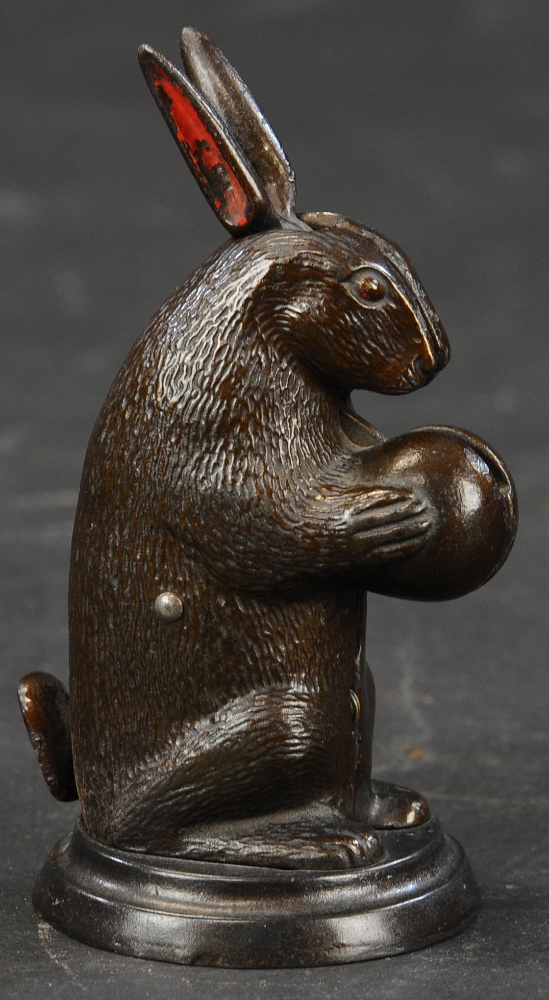 SMALL RABBIT STANDING MECHANICAL BANK: 237. SMALL RABBIT STANDING MECHANICAL BANK | Lockwood Mfg. of Connecticut, c.1882, nice jappaning with ears accented with red. | (Pristine Condition) | $600 - $900