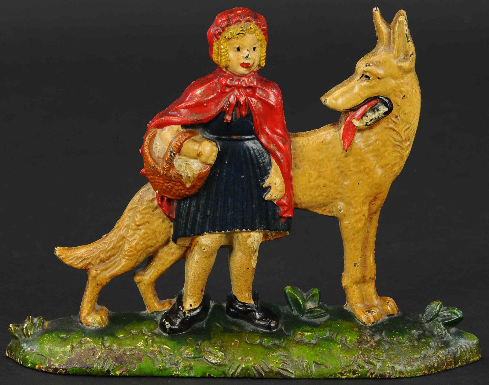 LITTLE RED RIDING HOOD DOORSTOP: 297. LITTLE RED RIDING HOOD DOORSTOP | Embossed "Red Riding Hood and Wolf NUYDEA, Patented. Pending," a favorite fairy tale theme. | 9" l. | (Pristine Condition) | $500 - $750