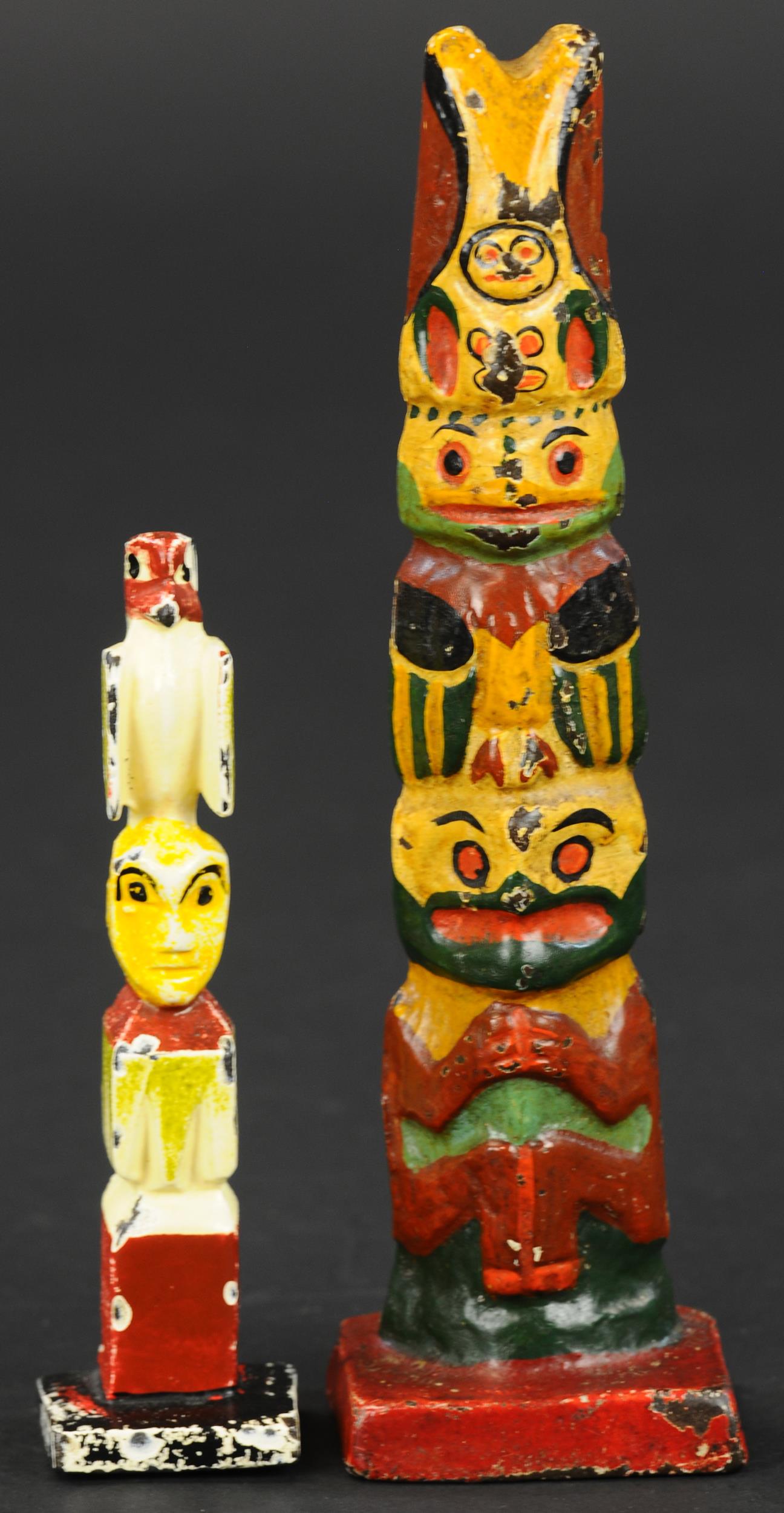 TOTEM POLE DOORSTOP & PAPERWEIGHT: 311. TOTEM POLE DOORSTOP & PAPERWEIGHT | A brightly colored miniature carved totem pole on square base, great simulated carving, and a smaller paperweight. Provenance: Bill & Wendy Jones Collection. |