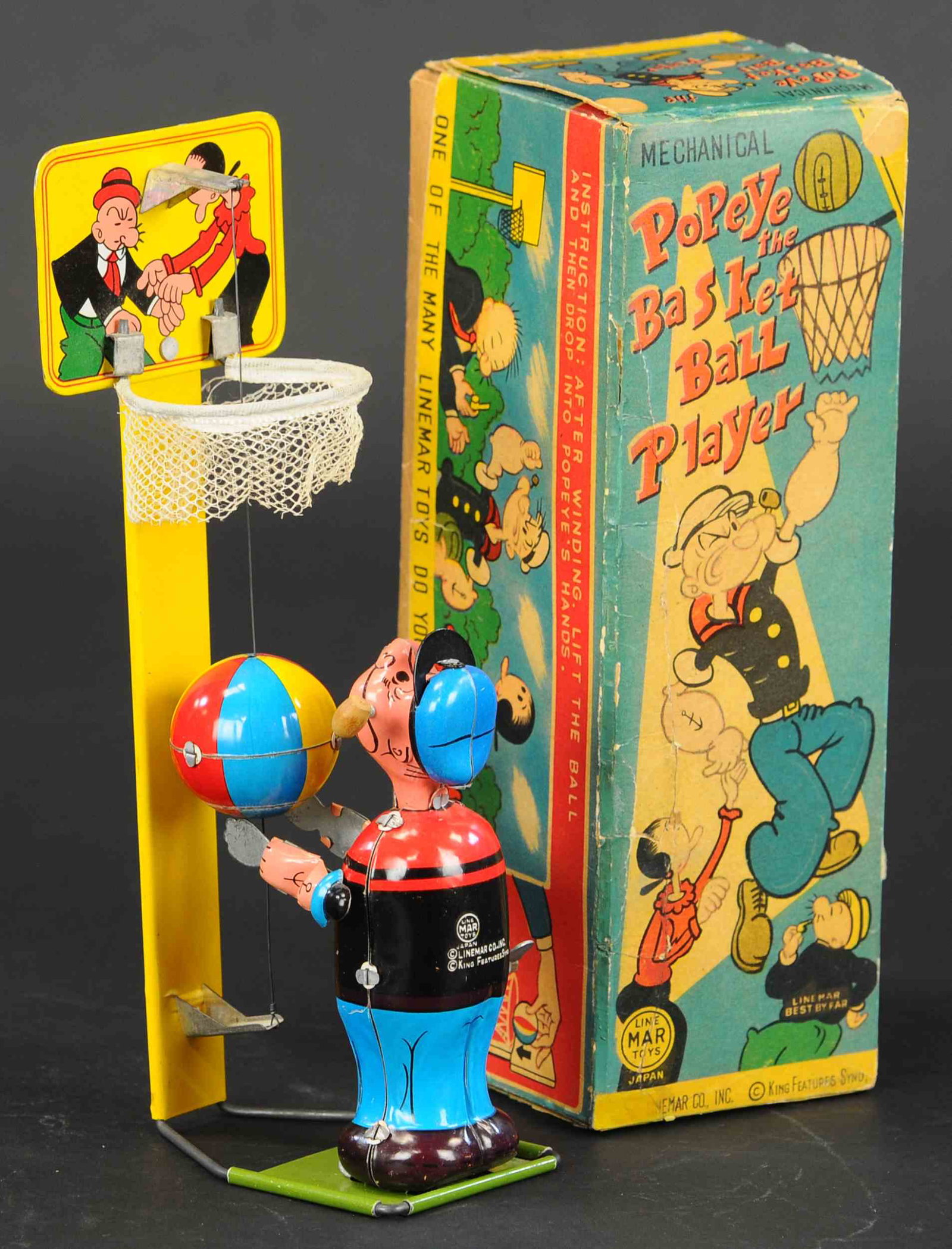 BOXED POPEYE BASKETBALL PLAYER: 329. BOXED POPEYE BASKETBALL PLAYER | Very popular an desirable Popeye toy with hard to find box. box lid and side flaps are covered in bright lithography art. | 9" h. | Minor edge enhancement on box 