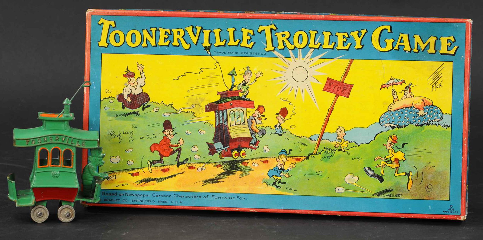 DENT TOONERVILLE W/ BOARDGAME: 349. DENT TOONERVILLE W/ BOARDGAME | Cast iron trolley with same theme Trolley board game. Provenance: Norm Schaut Collection. | 6" h. | Second casting, (Pristine to Near Mint Condition) | $300 - $600
