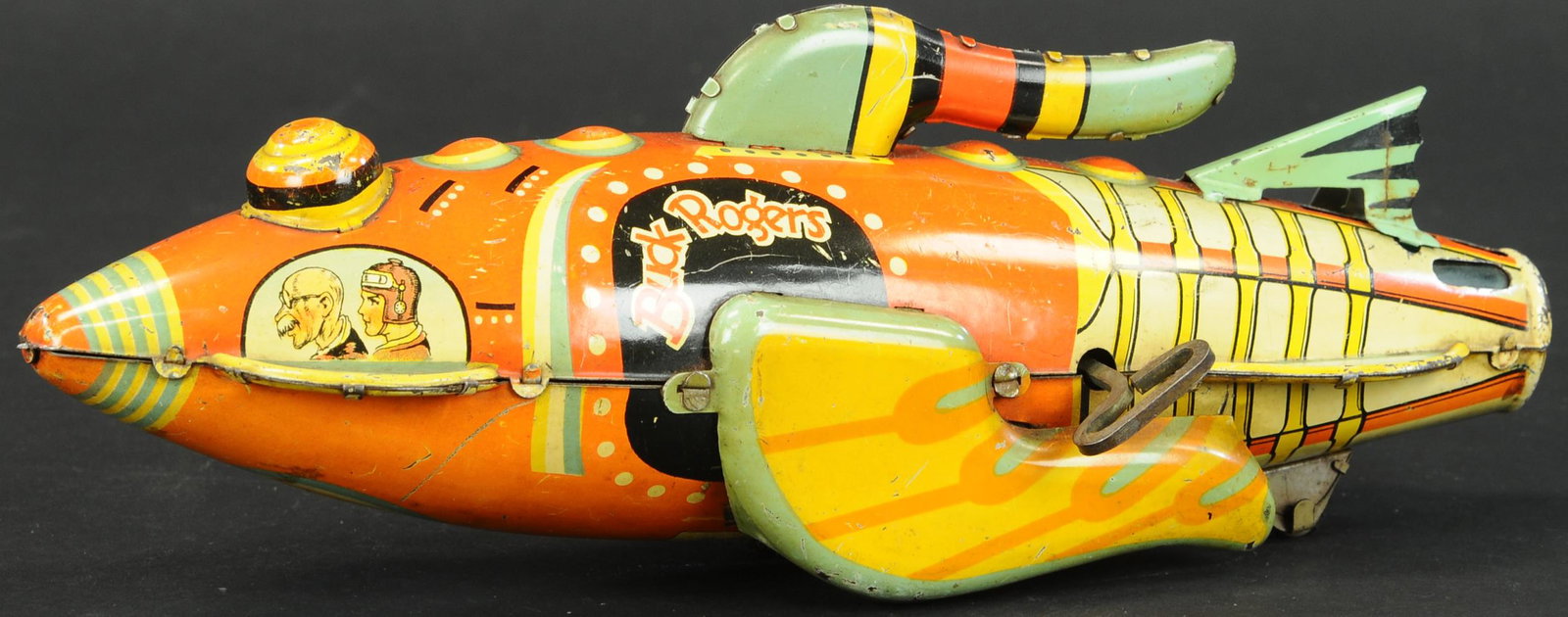 MARX BUCK ROGERS ROCKET SHIP: 382. MARX BUCK ROGERS ROCKET SHIP | Wonderful graphics and imagination throughout lithography. | 12" l. | Tailfin is replaced, otherwise in (Very Good Condition) | $400 - $600