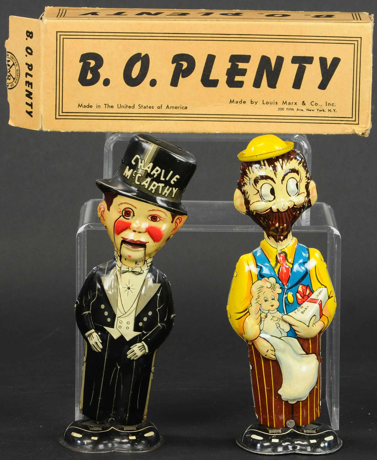 MARX B.O. PLENTY & CHARLIE MCCARTHY WALKERS: 400. MARX B.O. PLENTY & CHARLIE MCCARTHY WALKERS | 8.5" h. | End flaps are torn and repaired, toys in (Excellent Condition) | $200 - $300
