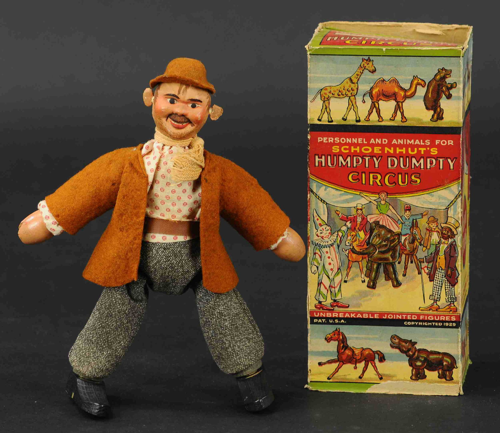 BOXED SCHOENHUT HOBO FIGURE: 420. BOXED SCHOENHUT HOBO FIGURE | Seldom found original cardboard box covered in great lithography. | 8" h. | Ears replaced, two end flaps on box torn but present, otherwise in (Pristine to Near Mint