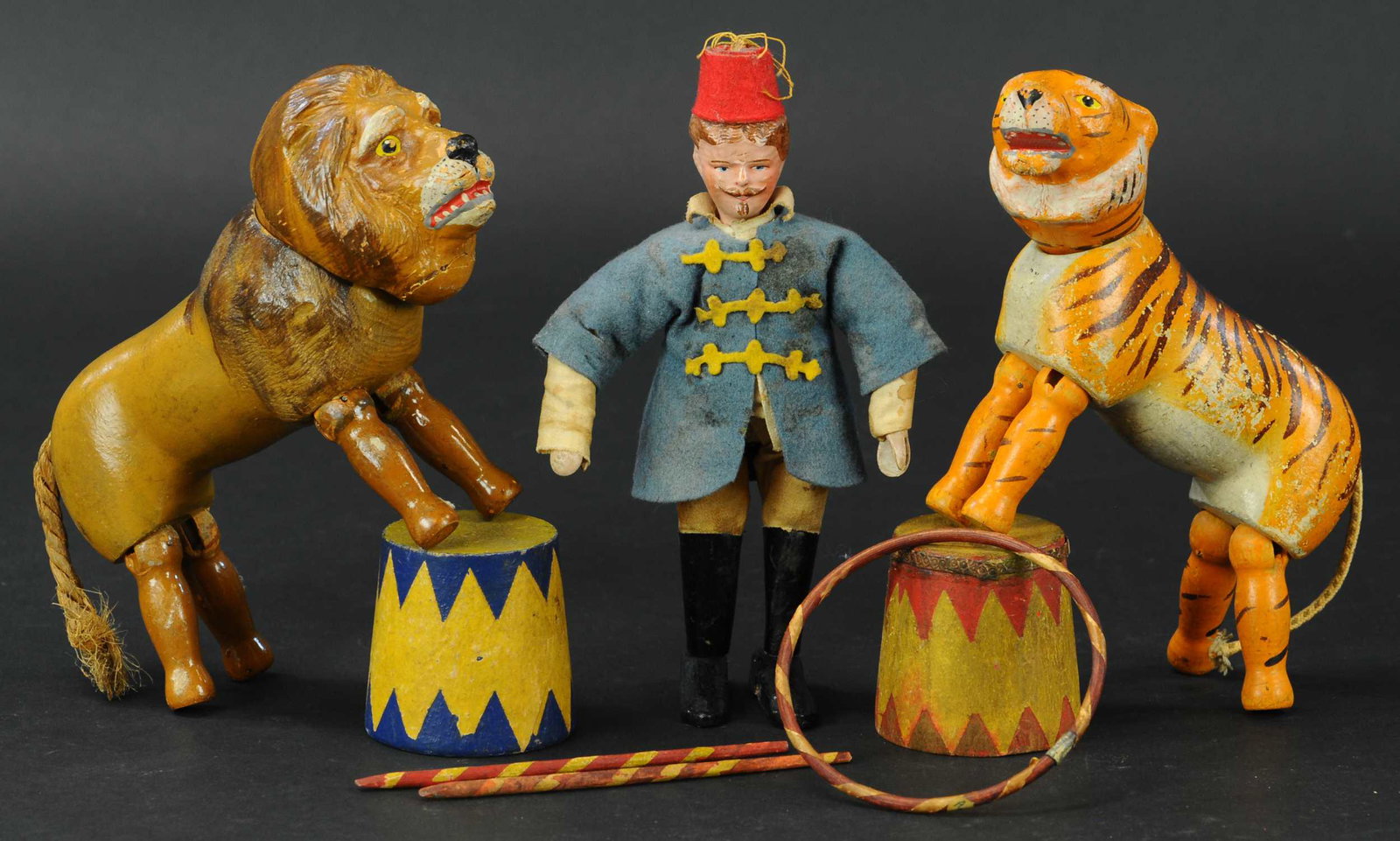 LION TAMER W/ ANIMALS AND PROPS: 434. LION TAMER W/ ANIMALS AND PROPS | Includes two circus barrels, a ring, and staffs. | 8" h. | (Excellent Condition) | $300 - $600