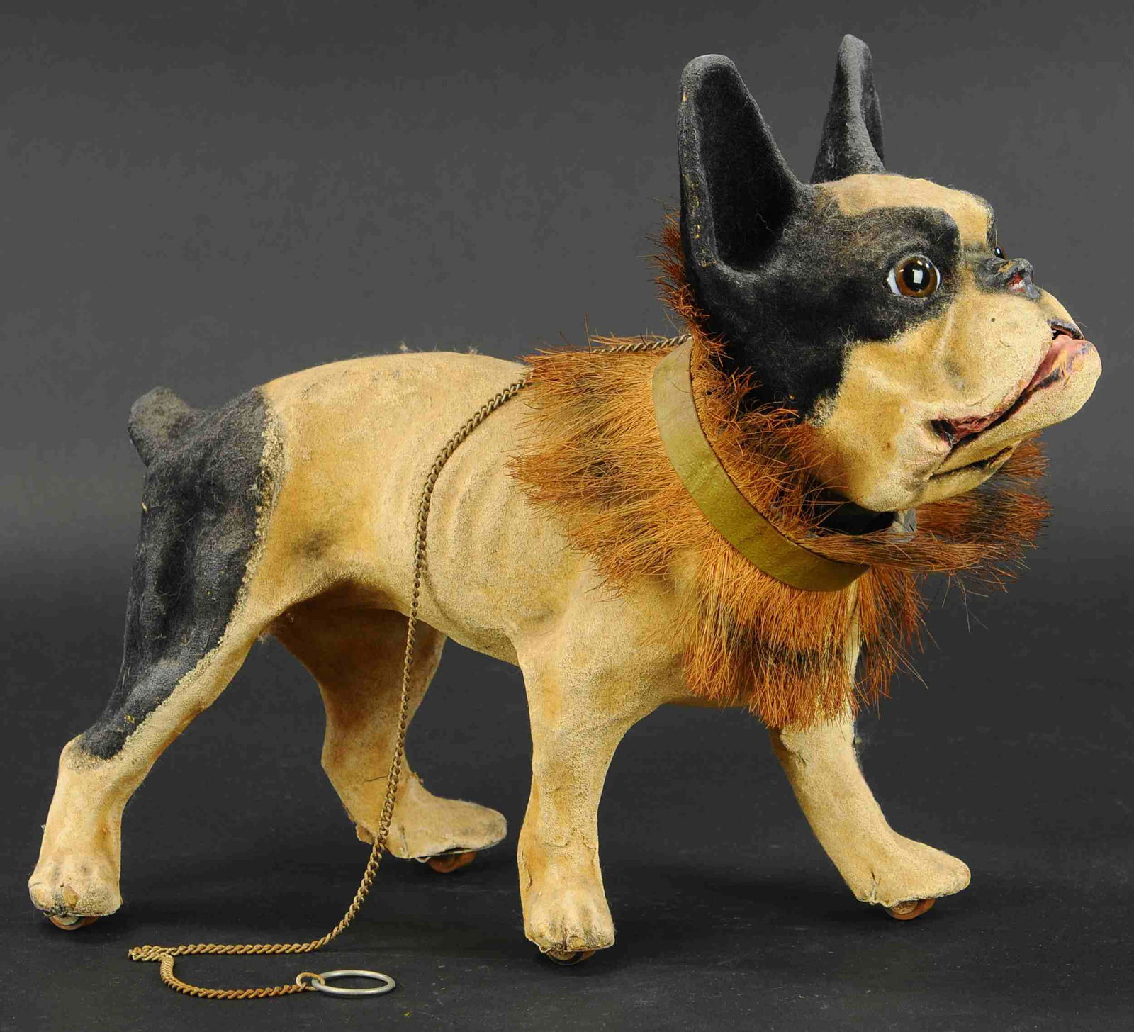 EARLY FRENCH BULLDOG GROWLER PULL TOY: 475. EARLY FRENCH BULLDOG GROWLER PULL TOY | Painted composition with big brown glass eyes, when chain is pulled, his head nods, jaw opens with a growling sound and still retaining his straw collar. |