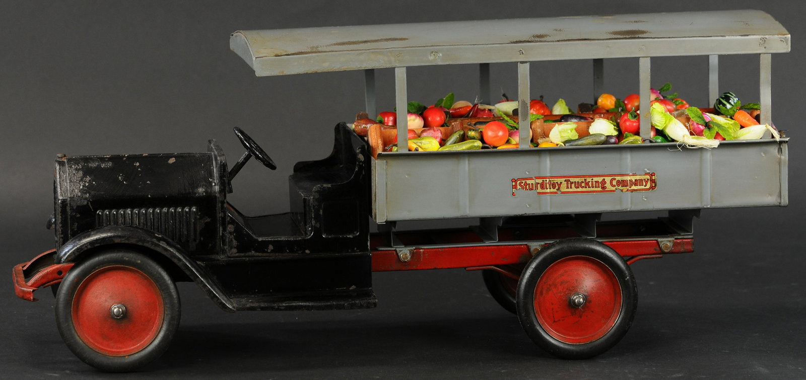 STURDITOY TRUCKING COMPANY TRUCK: 635. STURDITOY TRUCKING COMPANY TRUCK | 27" l. | Black fenders have some overpaint, grey portion appears to be restored. | $700 - $1,000