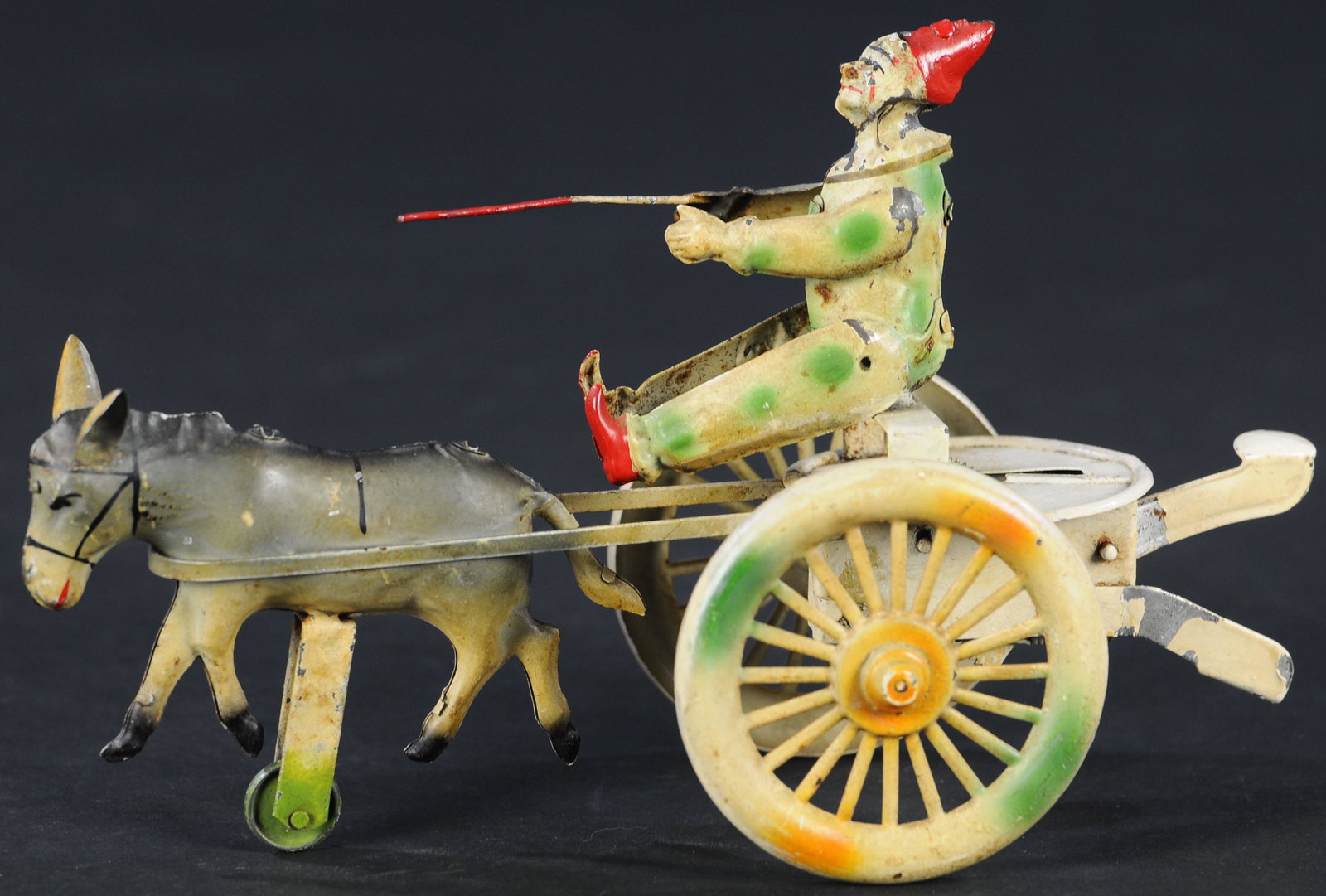 CLOWN MULE CART SQUEEZE TOY: 1120. CLOWN MULE CART SQUEEZE TOY | Germany, made by Praeger, motion driven by squeezing tabs at rear. | 10" l. | (Excellent Condition) | $200 - $400